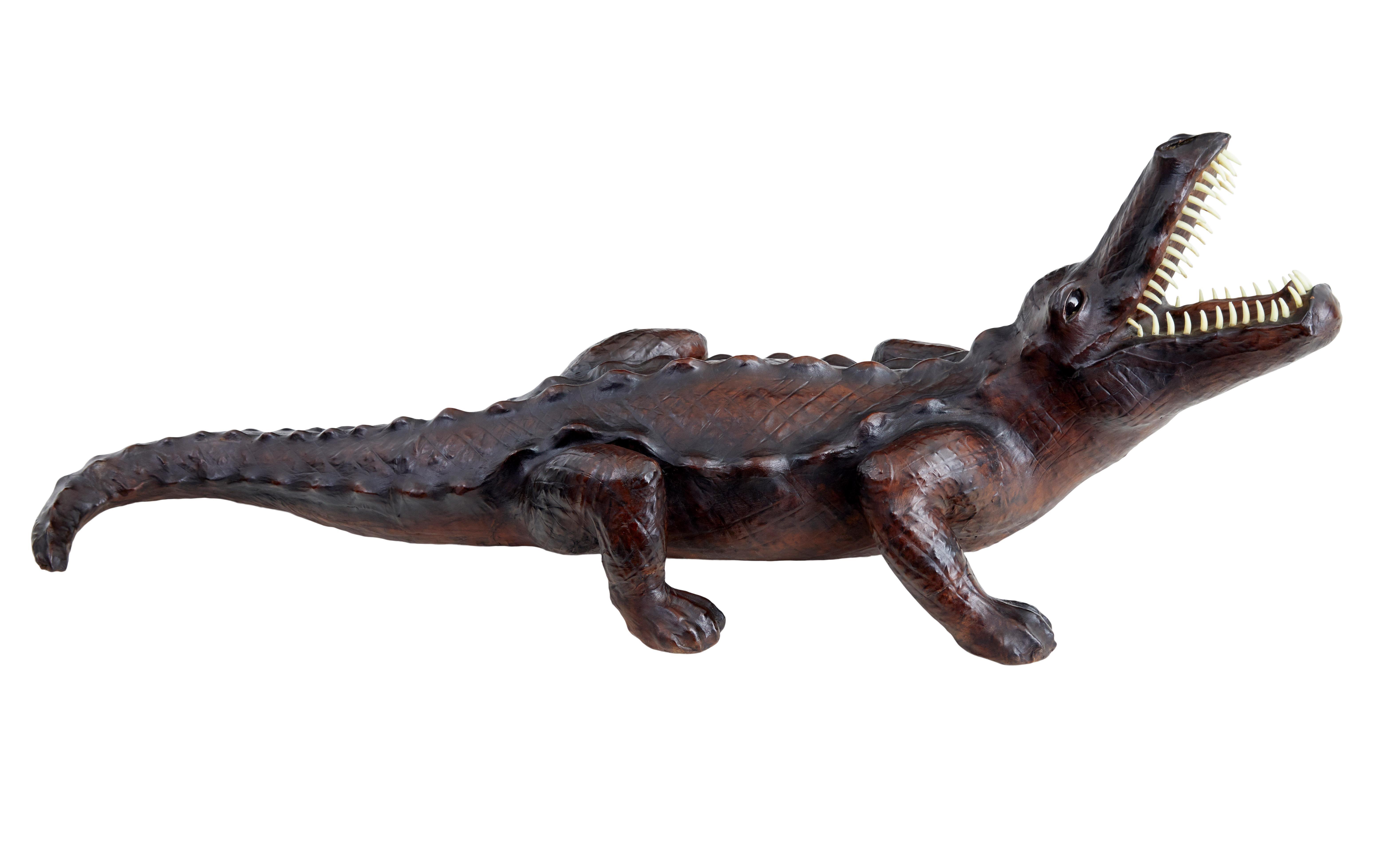 20th century decorative leather model of a crocodile circa 1990.

Approximately half scale novelty item, depicting a crocodile with it's head raised in an aggressive stance.  Clad in a faux leather which has produced a good patina.

Mouth fitted