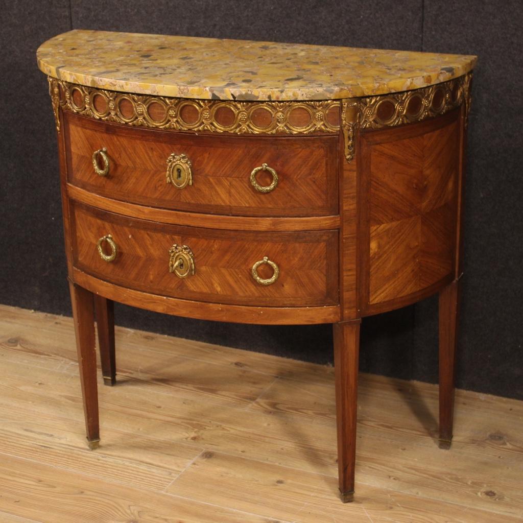 French demilune dresser from 20th century. Louis XVI style furniture richly adorned with gilded and chiselled bronze inlaid in mahogany, rosewood, walnut and fruitwood. Chest of drawers with two drawers complete with a working key (drawer lock at