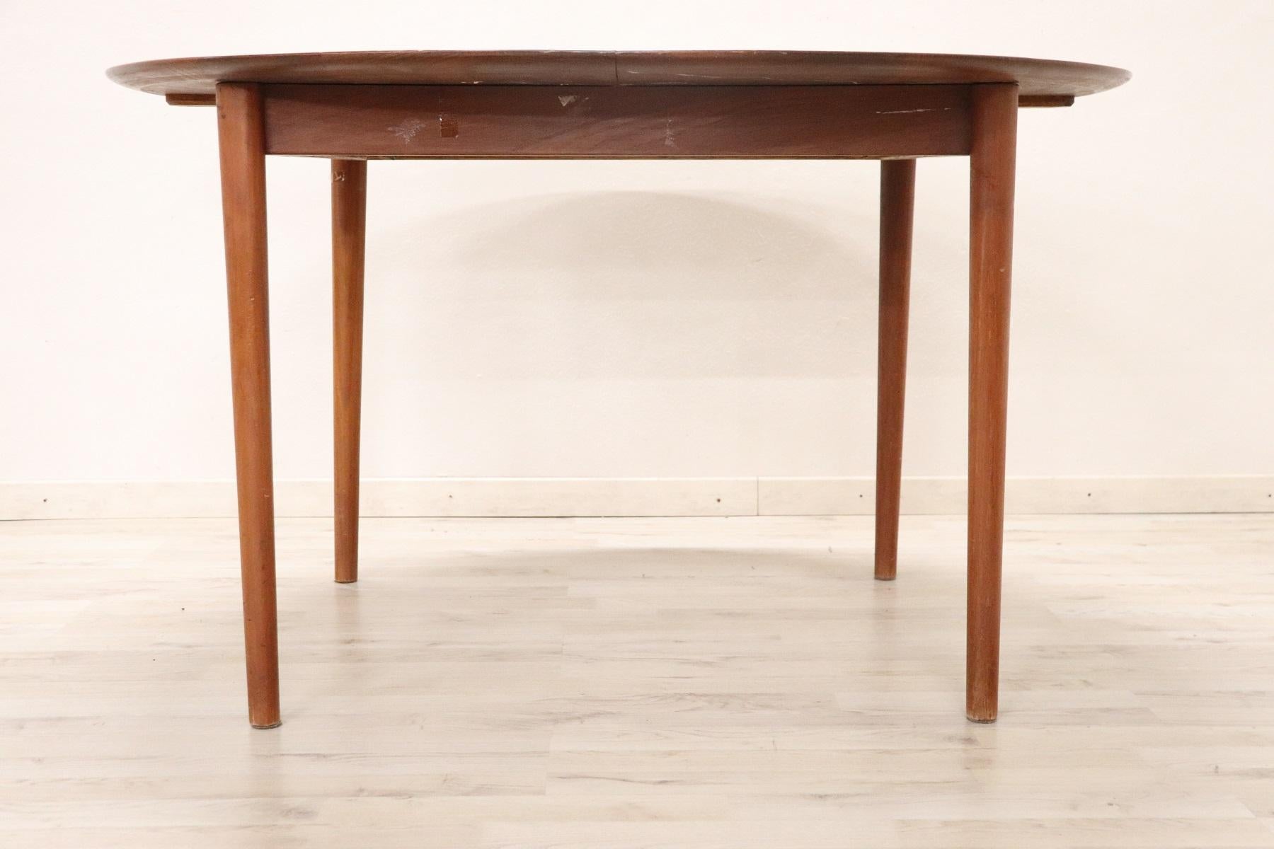 Refined teak design table by Peter Hvidt for Søborg 1950s. This table extends with an opening in the center. Support surfaces to be placed in the center are not included. Brand under the design manufacturing plan. Perfect dining table for a modern