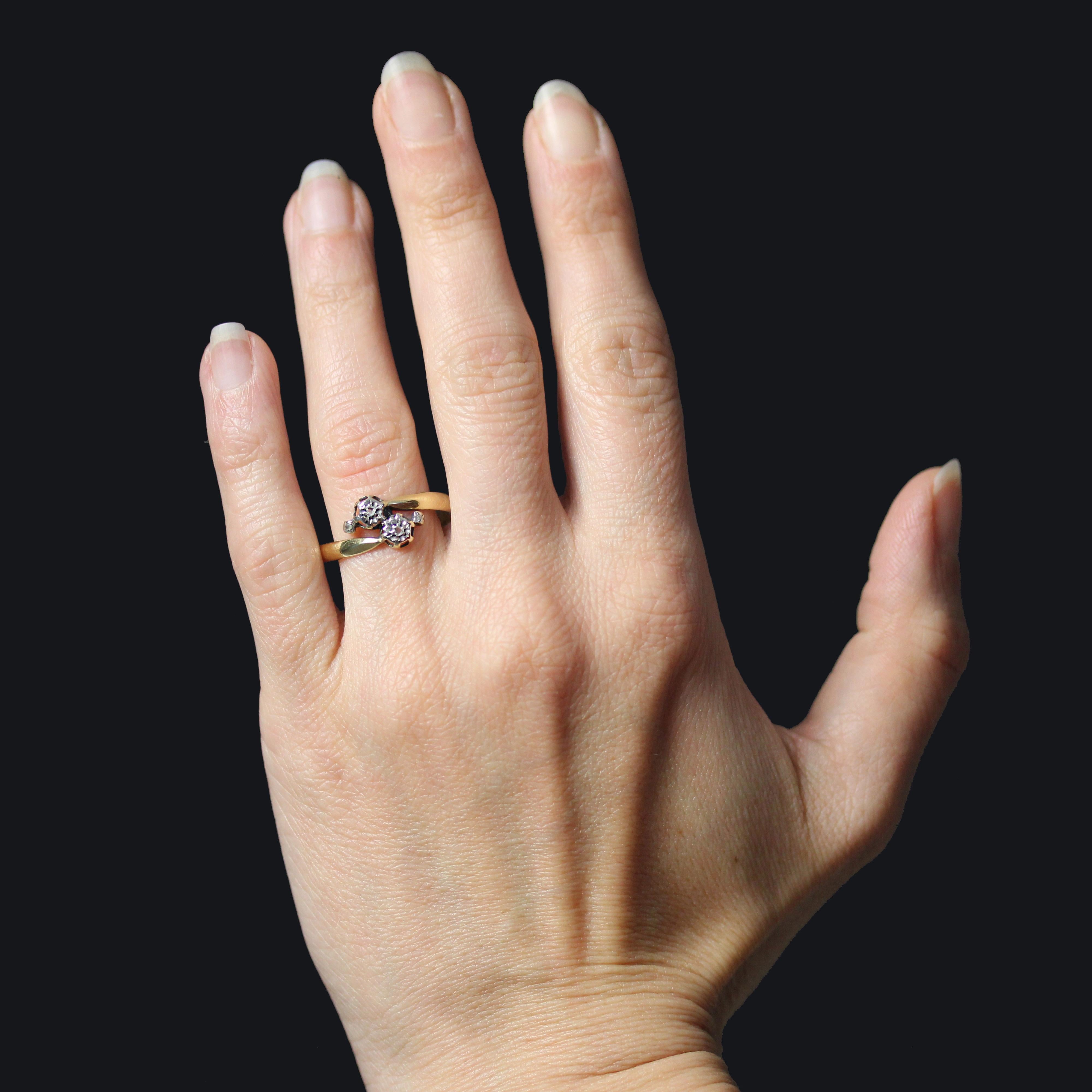 Ring in 18 karat yellow gold.
Antique ring called Toi et Moi, adorned at the top with two star-set rose-cut diamonds. The ring is asymmetrical, with two rose-cut diamonds set on either side.
Height : 9 mm approximately, width : 12 mm approximately,