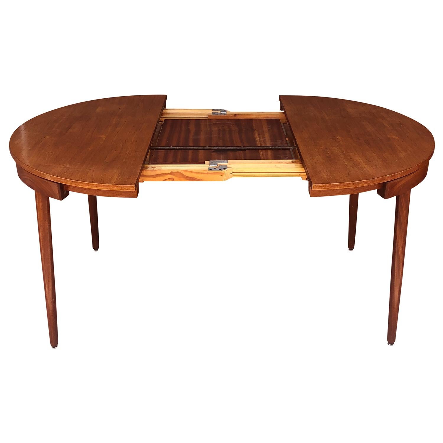 A unique Danish dining set made of walnut by Hans Olsen with four chairs which fully slide under the round table with only the backrests showing along the perimeter. Wear consistent with age and use, circa 1950–1960 Denmark, Scandinavia.
Chairs: