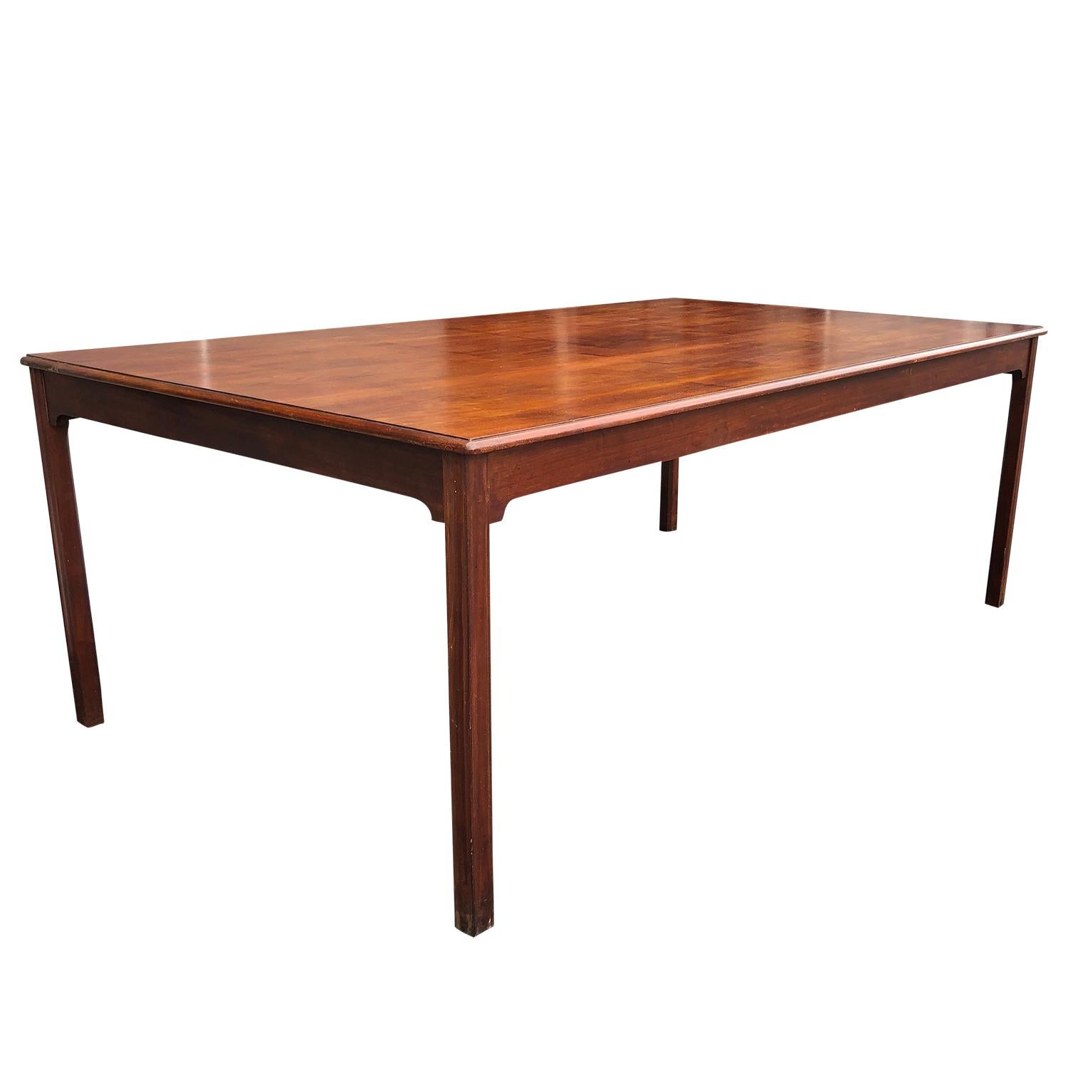 A rectangular, vintage Mid-Century Modern Danish dining table made of hand crafted polished Cuban Mahogany. The Scandinavian conference table was designed by Kaare Klint, in good condition. Minor scratches, due to age. Wear consistent with age and
