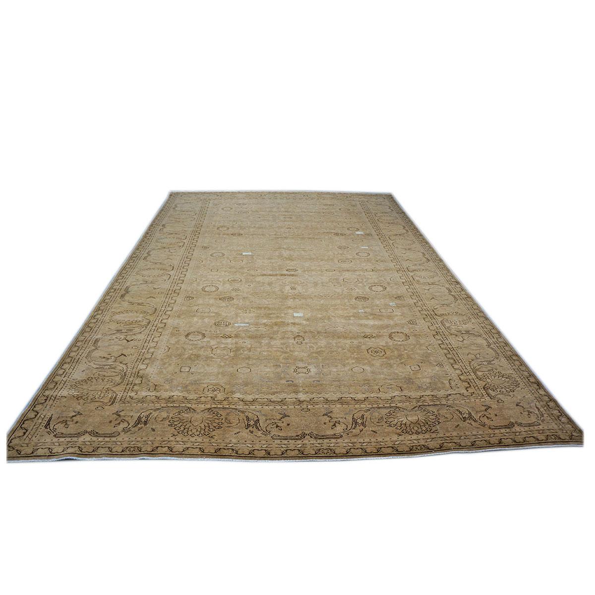 20th century hand-woven antique distressed Persian Malayer 9x12 wool living-room rug. Woven by weavers in Persia in the 1930s with hand-spun wool and sun-washed by our expert colorist. This piece consists of an all-over brown colored background