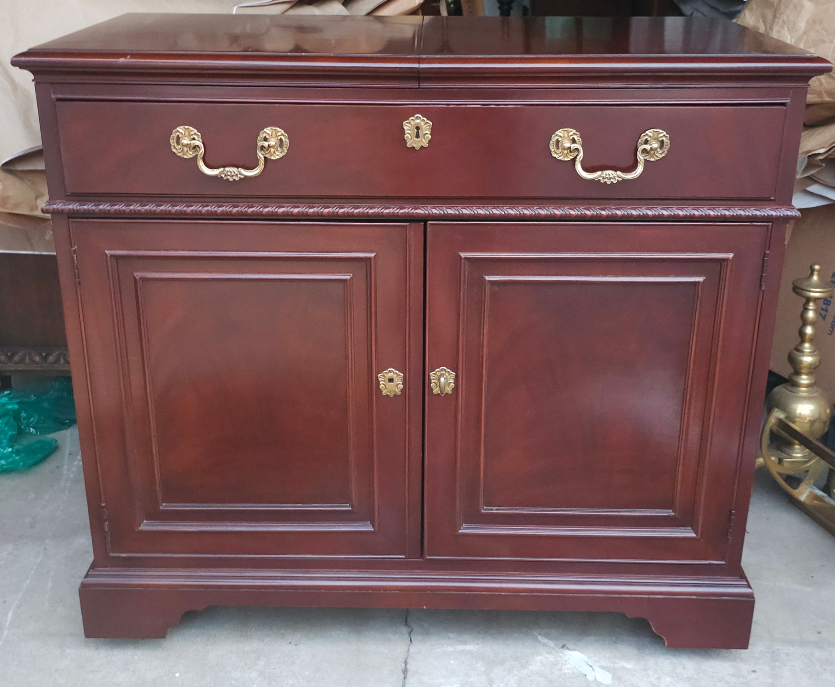 A 20th Century Drexel Mahogany Slide Top Rolling Dry Bar Buffet Server in great vintage condition edition. Features two top drawer with felt line tray. Measures 38