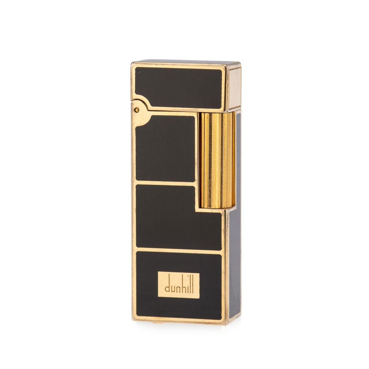 A beautiful brass and black enamel pocket lighter made by Dunhill, England, towards the later end of the 20th century. Presented with its original box and, unusually, even the original cardboard box, hardly ever seen as they are usually discarded,