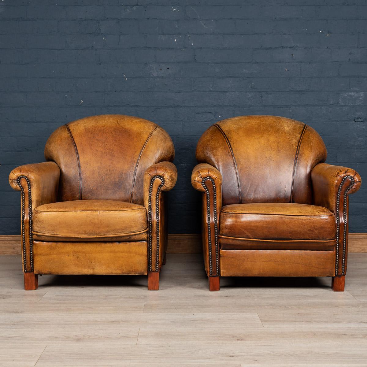 Showing superb patina and color, this wonderful pair of club chairs were hand upholstered sheepskin leather in Holland by the finest craftsmen. Fantastic look for any interior, both modern and traditional.

   
  