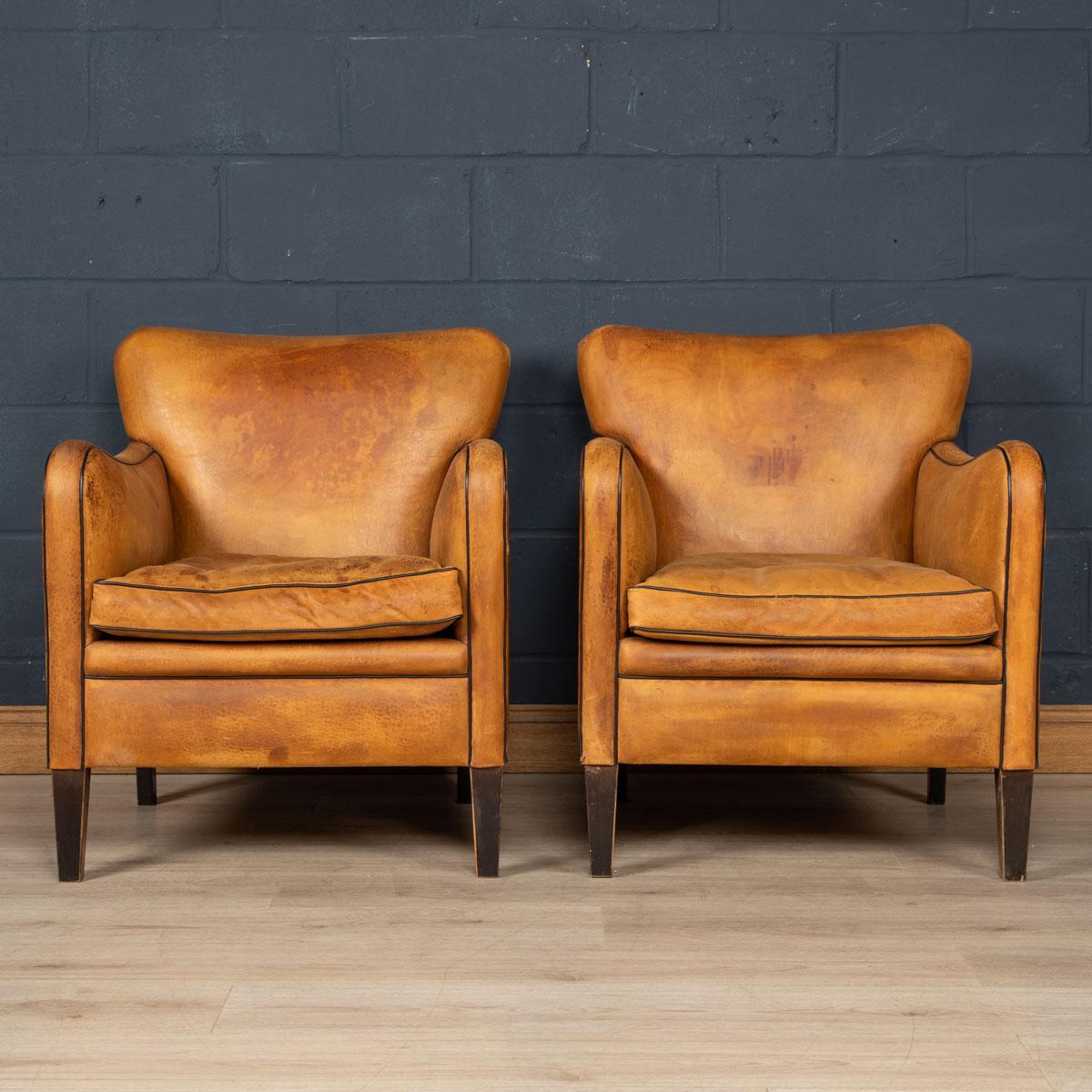 Showing superb patina and colour, this wonderful pair of club chairs were hand upholstered sheepskin leather in Holland by the finest craftsmen in the latter part of the 20th century.

CONDITION
In Good Condition - Some wear consistent with