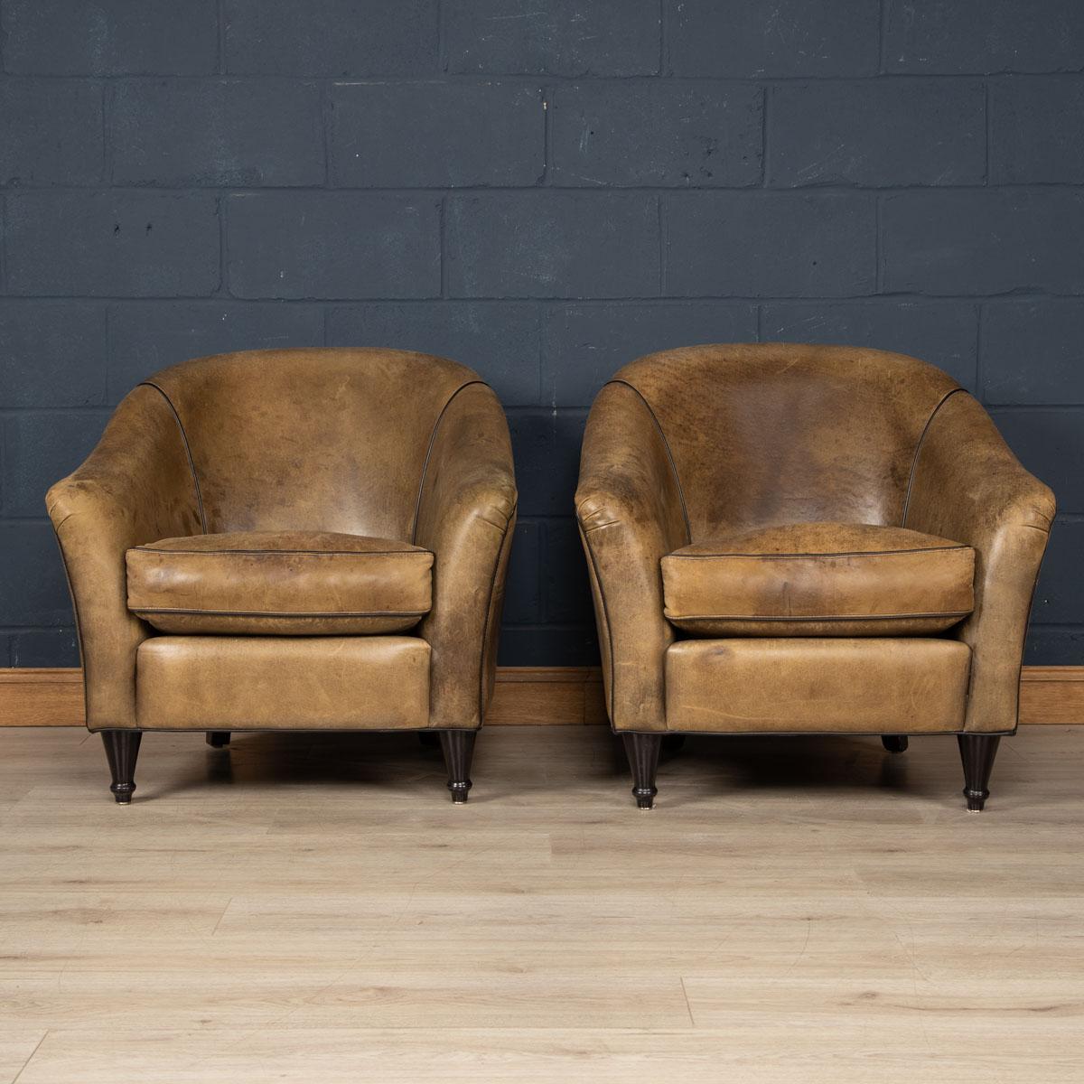 Showing superb patina and colour, this wonderful pair of club chairs were hand upholstered sheepskin leather in Holland by the finest craftsmen in the latter part of the 20th century.

CONDITION
In good condition - Some wear consistent with normal