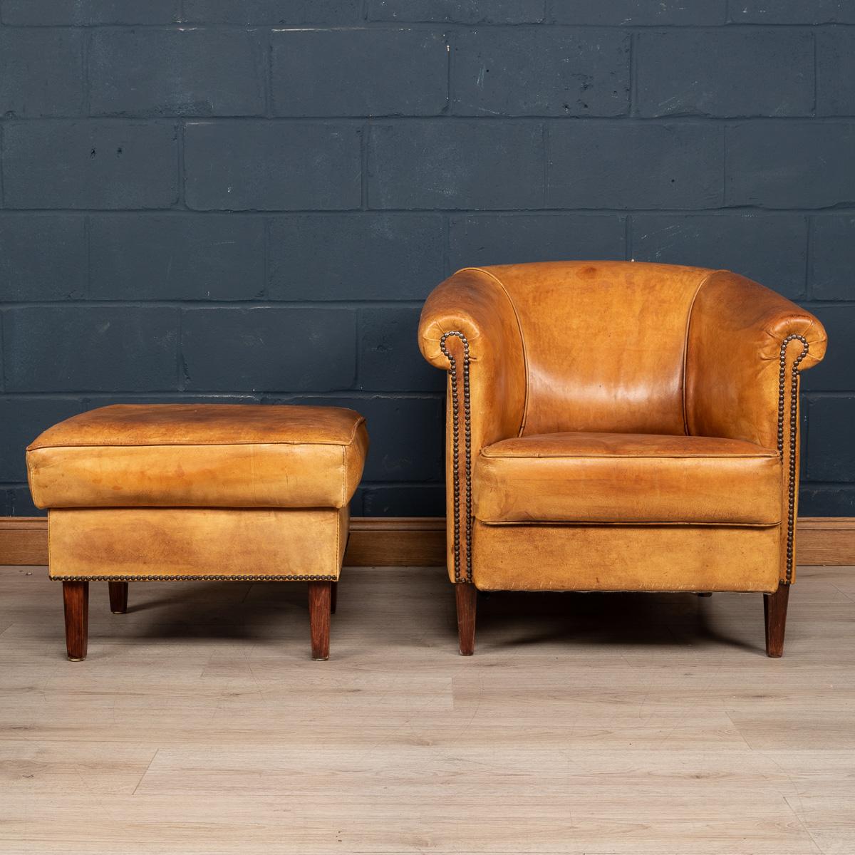 A charming tub chair and matching footstool, hand upholstered sheepskin leather by the finest craftsmen in Holland. The design and craftsmanship of sheep leather furniture was perfected in Holland and spread to other countries in northern