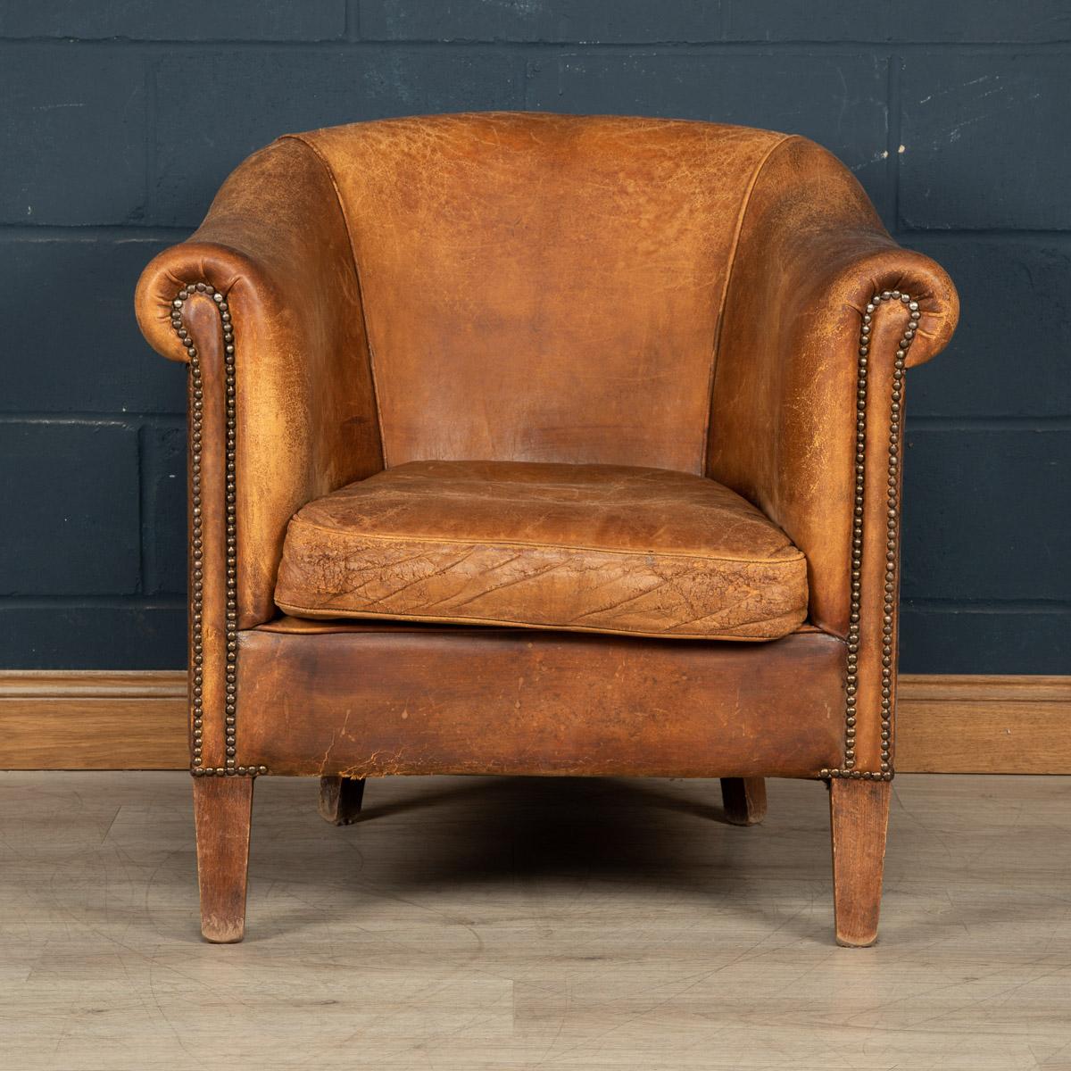 Showing superb patina and colour, this wonderful club chair was hand upholstered sheepskin leather in Holland by the finest craftsmen.

Condition
In Good Condition - some wear consistent with normal use, darkening to the armrests where the chair