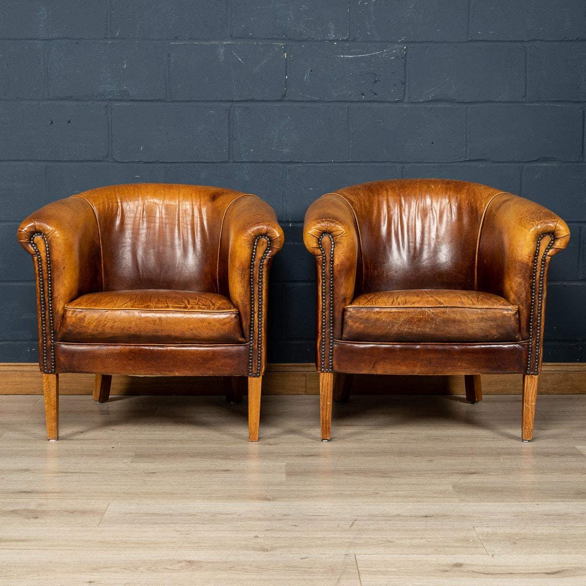 Showing superb patina and colour, this wonderful pair of club chairs were hand upholstered sheepskin leather in Holland by the finest craftsmen in the latter part of the 20th century.

CONDITION
In Good Condition - Some wear consistent with normal