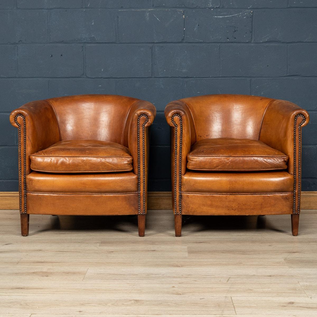 Showing superb patina and colour, this wonderful pair of club chairs were hand upholstered sheepskin leather in Holland by the finest craftsmen in the latter part of the 20th century.

CONDITION
In Good Condition - Some wear consistent with normal