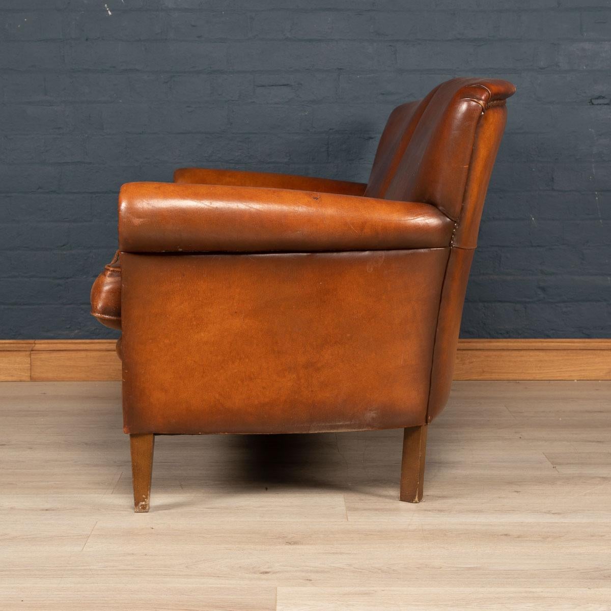 A very elegant two-seat leather sofa, mid-late 20th century, manufactured in Holland and of the finest quality with great patina.

