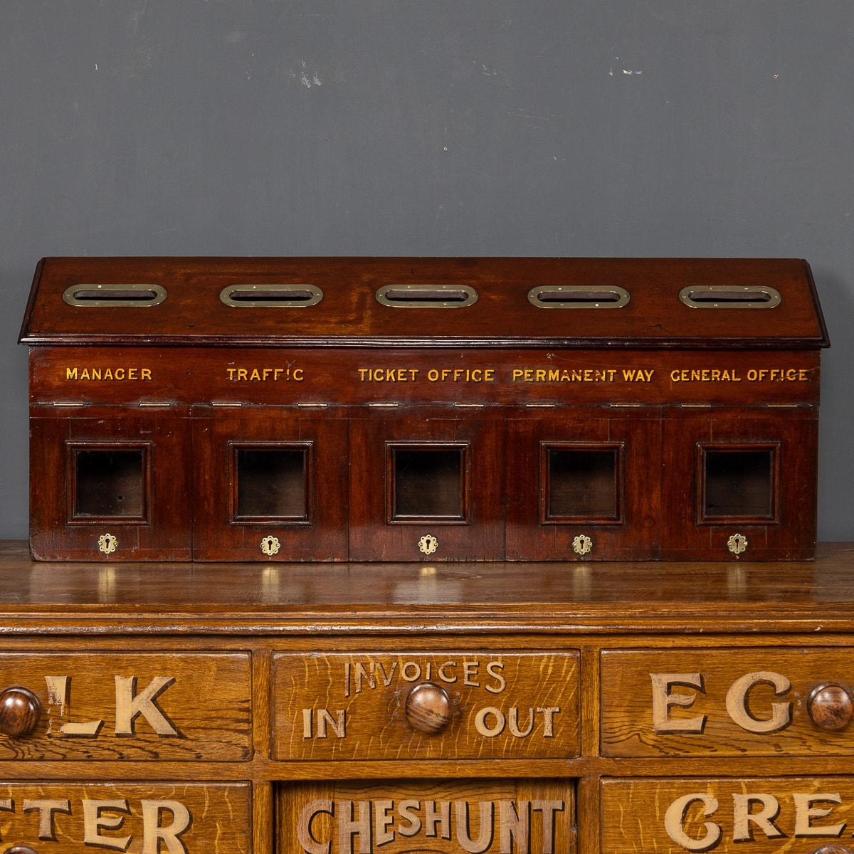 Antique 20th century English mahogany mailbox used in the office of a train station with a brass details, locks and keys.

CONDITION
In Great Condition - wear as expected.

SIZE
Width: 110cm
Height: 41cm
Depth: 15cm