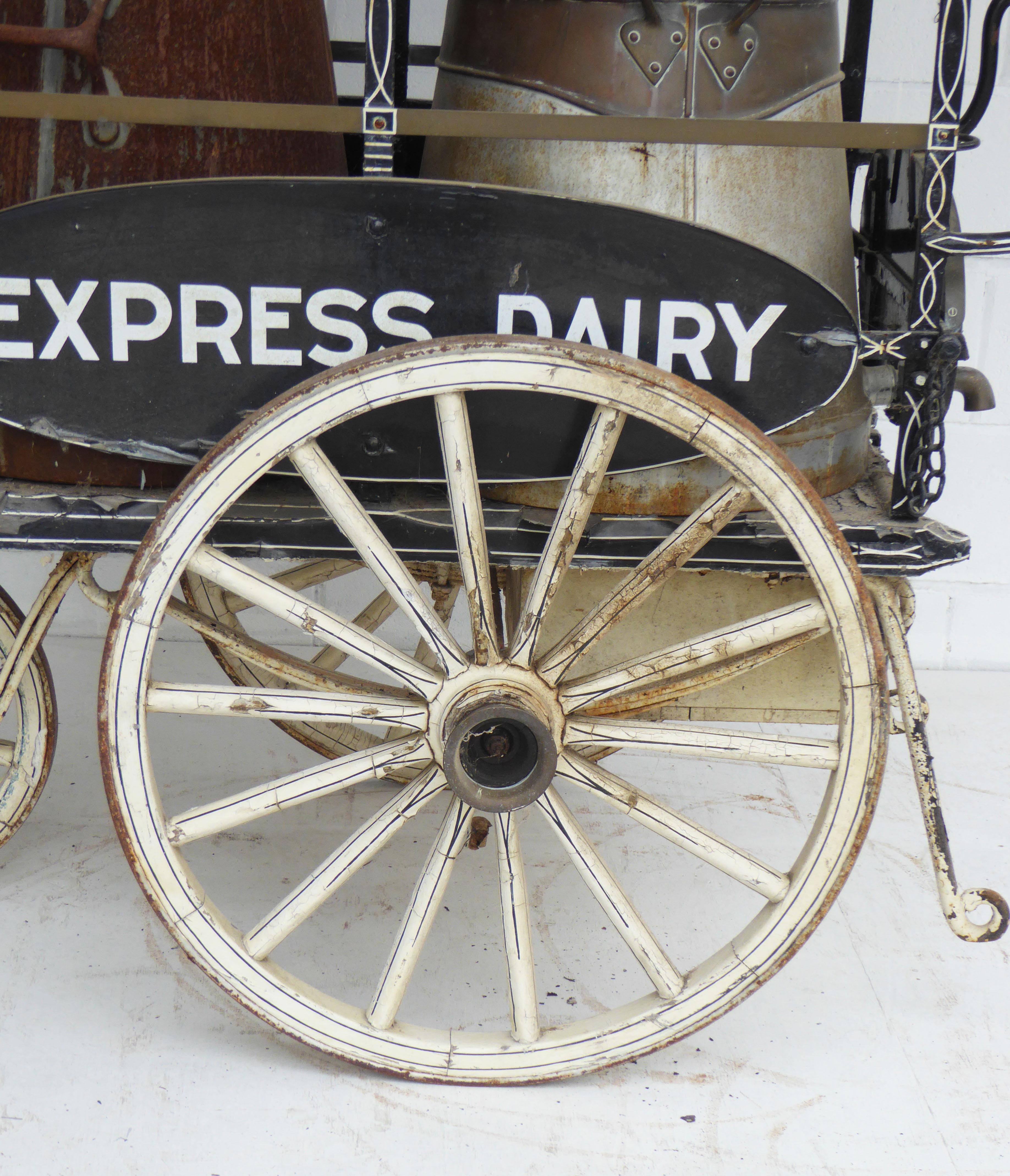 For sale is an unusual Edwardian hand pulled milk cart. The milk cart has two large churns, on of which with a badge stating 