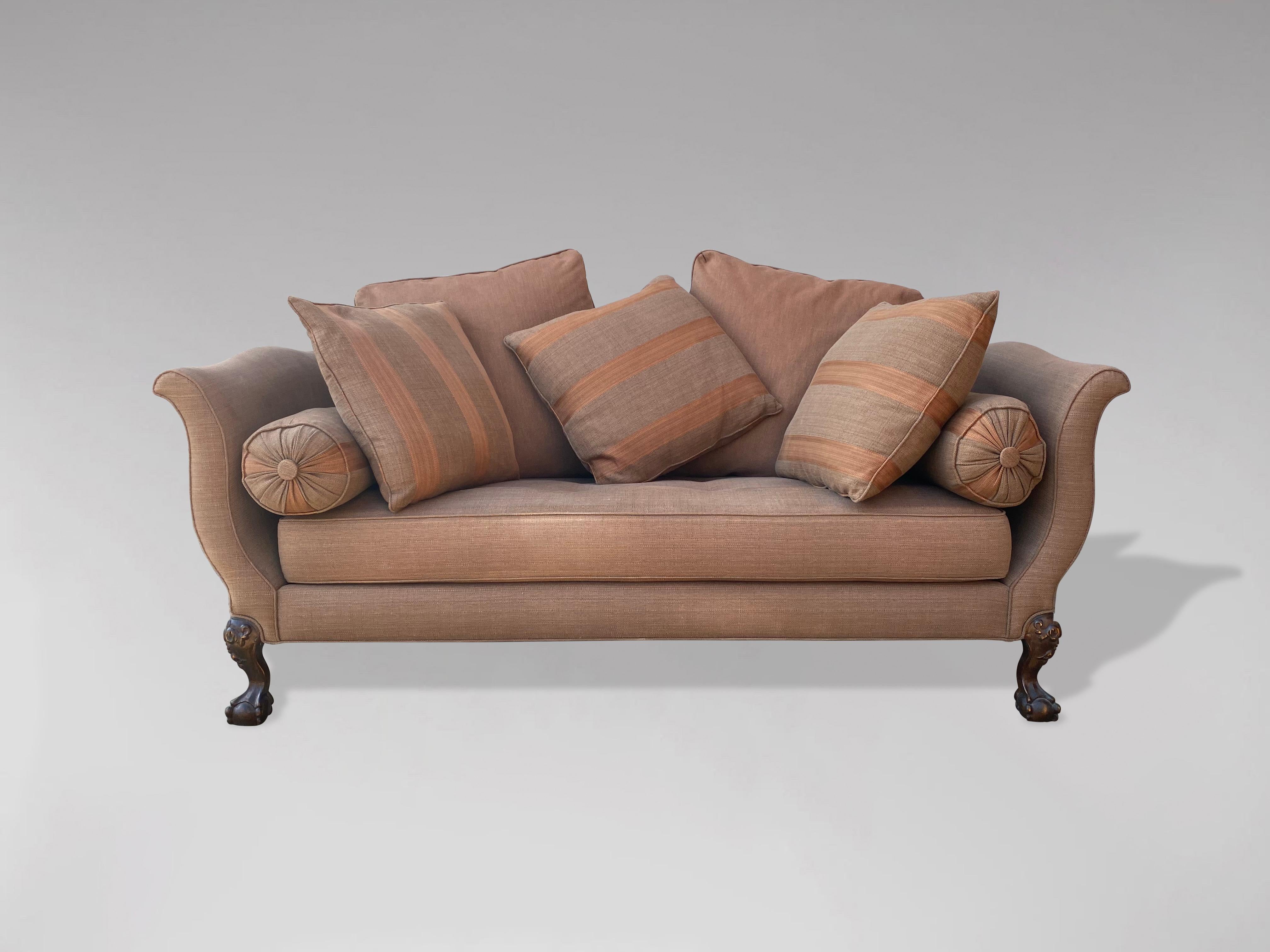 A magnificent country house example of an early 20th century, Edwardian period, George II style camel back sofa. Having shaped back and outswept scrolled and curved arms. Standing on mahogany carved cabriole legs ending on claw and ball feet. All