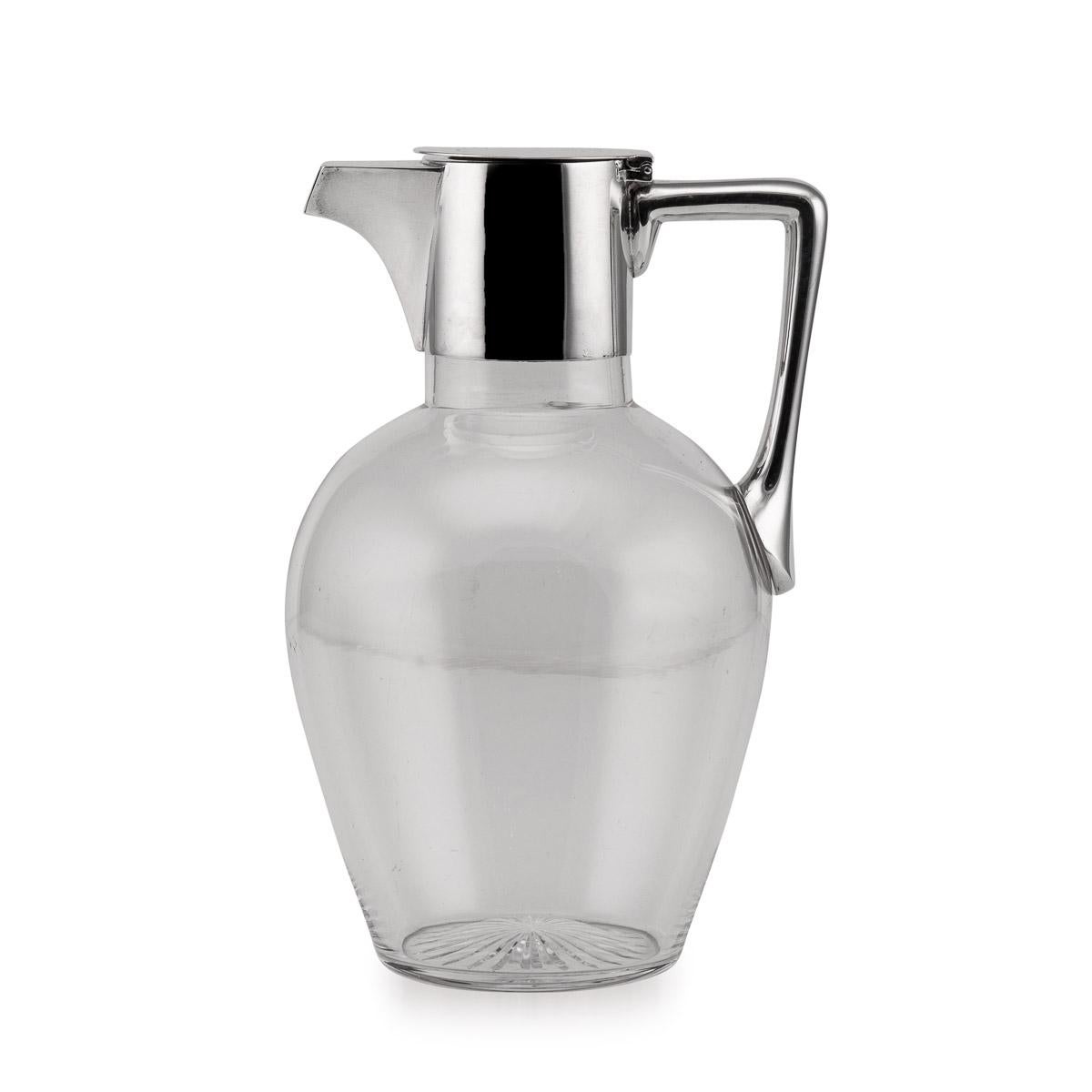 20th Century Edwardian silver & plain glass wine jug, the glass mounted with a plain solid silver collar and hinged lid.

Hallmarked English Silver, London, year 1902 (g), Maker JTH JHM (Hukin & Heath).

CONDITION
In great condition - no
