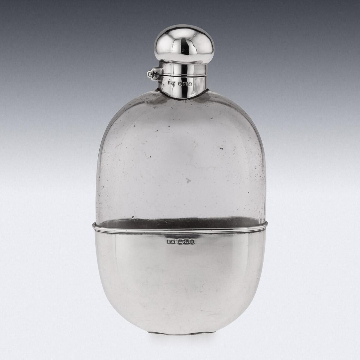 Antique early-20th century Edwardian solid silver and glass mounted hip flask, with silver hinged screw top and removable cup. Hallmarked English silver (925 standard), Sheffield, year 1910 (g), Makers mark H.W (Lee & Wigfull, Henry