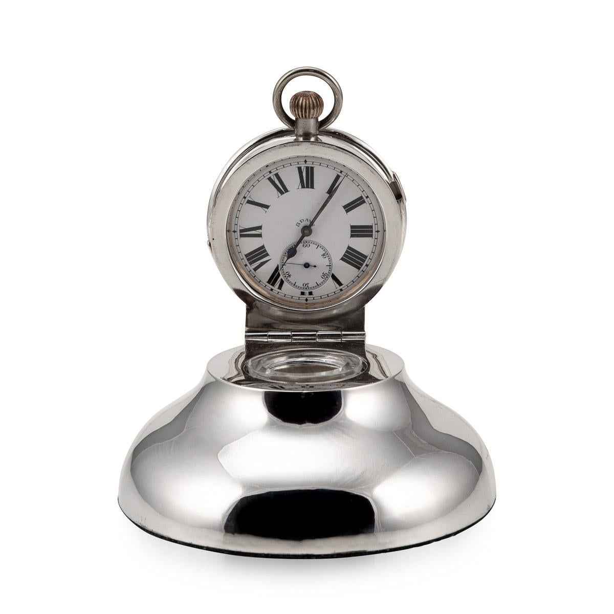 20th century Edwardian silver capstan shaped inkwell with an 8 day goliath clock. The hinged cover is set with a silver plated clock, with a white dial with Roman numeral markers and subsidiary second dial.

Condition
In great condition - no