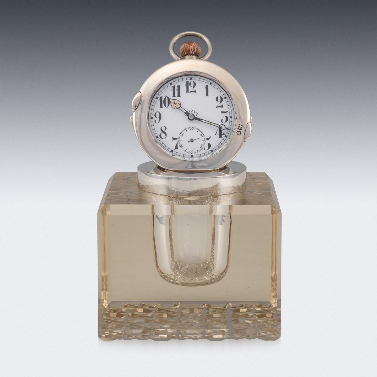 Antique early-20th century Edwardian solid silver & cut glass Inkwell with clock. The hinged cover is set with a 8 day goliath pocket watch, with a white dial with numbers and subsidiary second dial. The clock is in working condition. Hallmarked