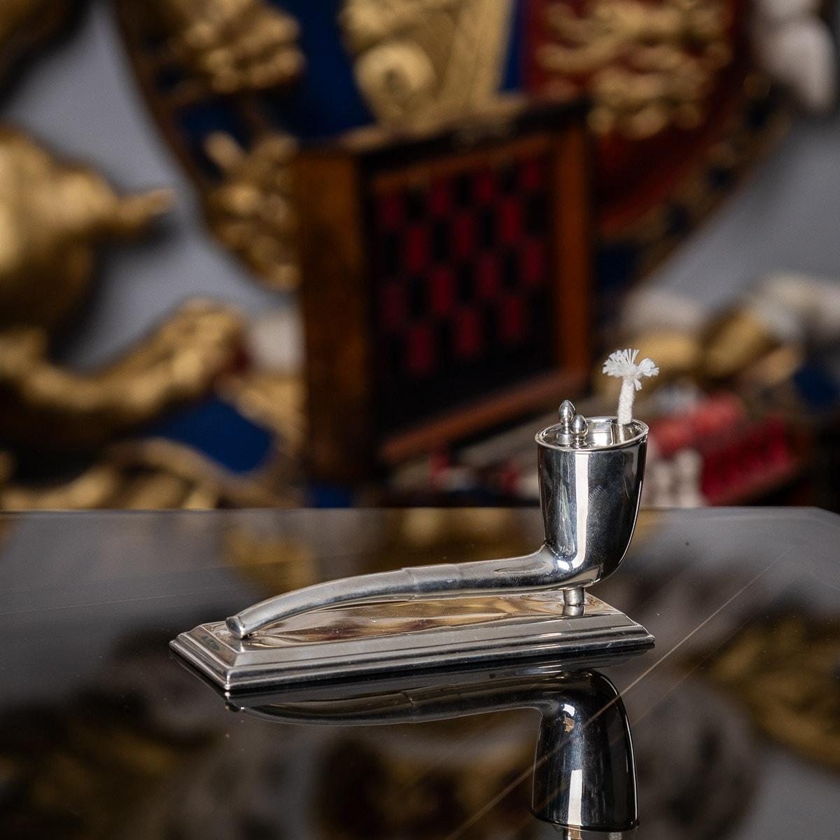 Antique early 20th century Edwardian solid silver table lighter, in a shape of a pipe on a rectangular stepped stand, the top with a wick and two lighters. Hallmarked English Silver (925 standard), Sheffield, year 1906 (o), Maker's mark J.R (John