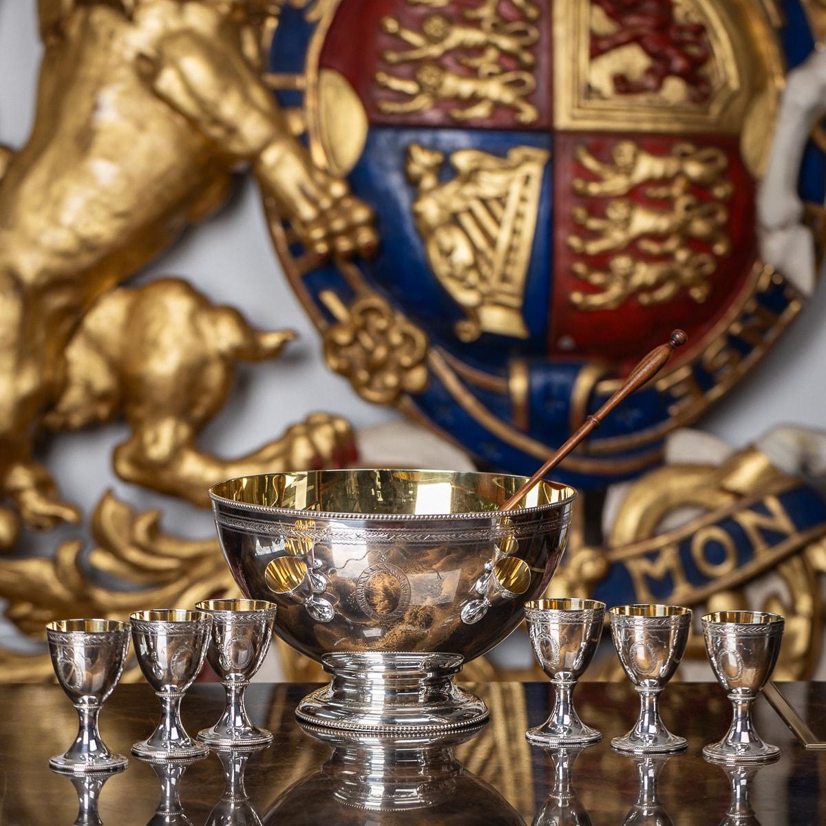 Superb 20th Century Elizabeth II solid silver punch set, consisting of a punch bowl, six goblets and a ladle, the circular bowl raised on a circular turned foot with beaded decoration along the rims, the side with three parallel bands of bright cut