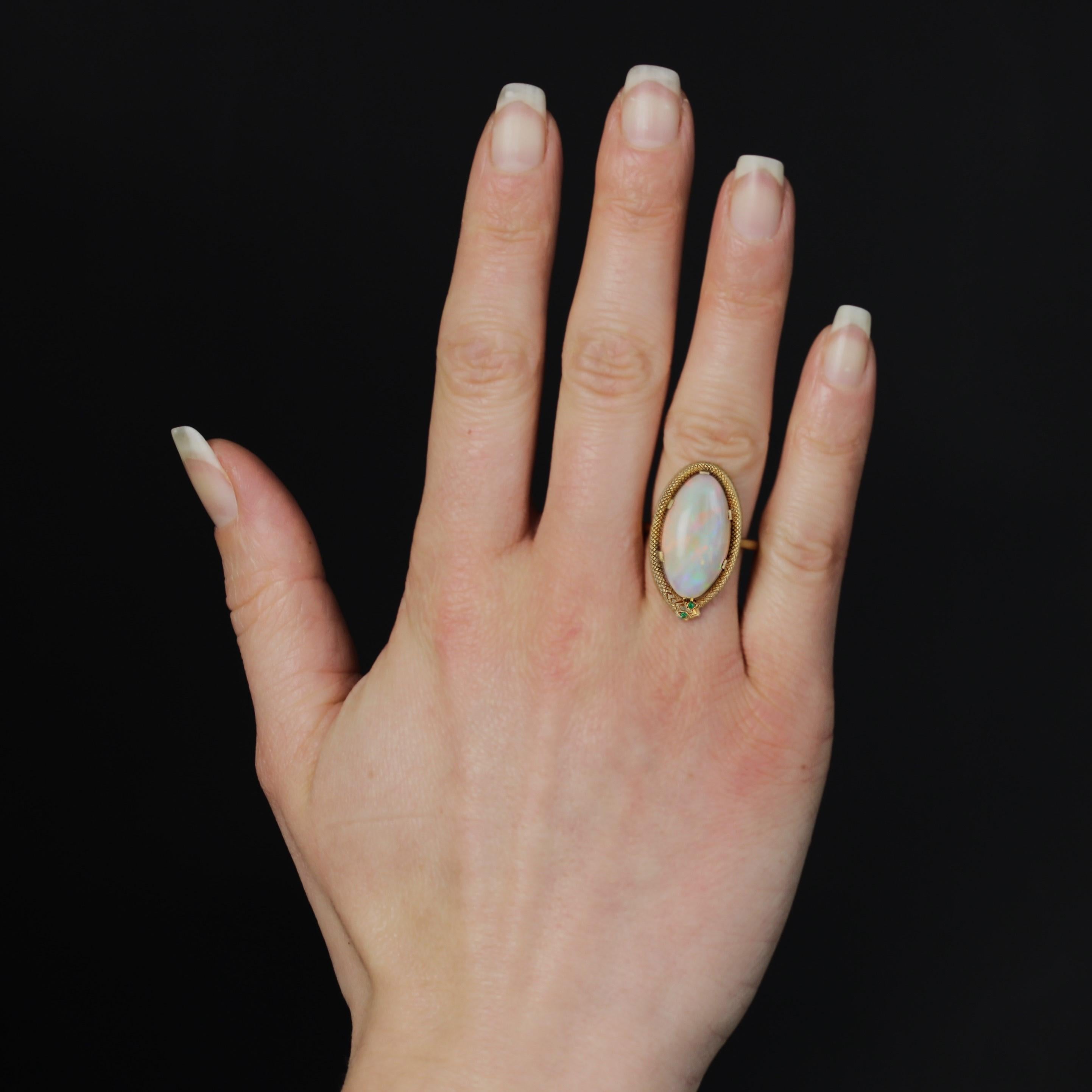 Ring in 18 karat yellow gold, eagle head hallmark.
This astonishing antique ring features a large oval cabochon opal on top, held in place by 6 flat claws and surrounded by a coiled snake, whose eyes are represented by 2 small emeralds.
Weight of