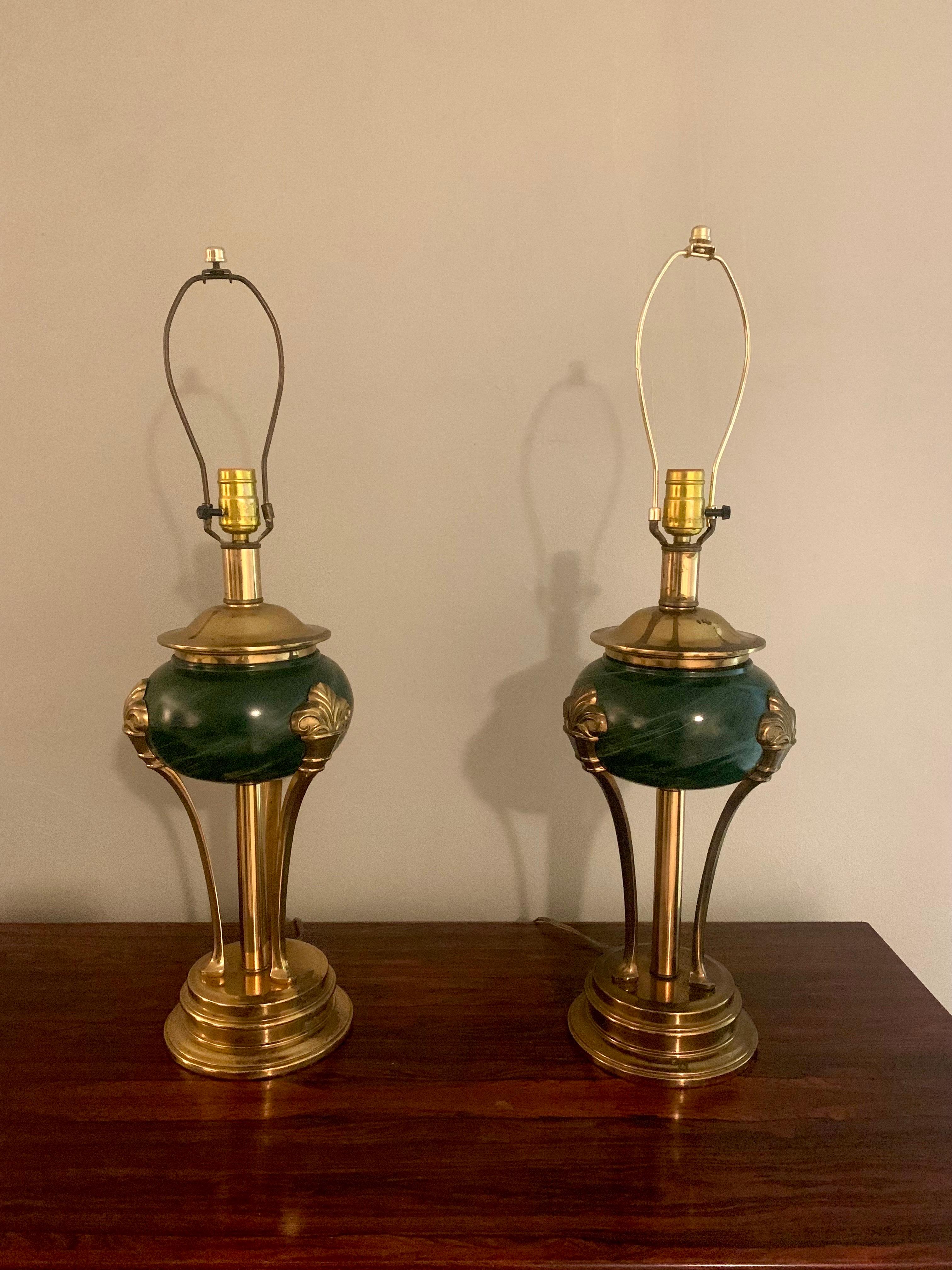 Gorgeous pair of neoclassical empire style lamps. Beautiful brass stands with 3 supports starting with a brass foot and ending with a Fleur D Lys adorning the green stone base. 

Unsure of origin, but definitely French inspired. 

Height: 29”