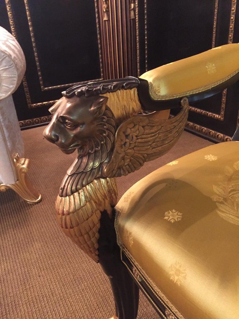 Imperial stylish lion Kanapee in Empire style. Finely detailed carving work on solid ebonized beechwood. Gilded. Winged, protruding lions heads in bronze.