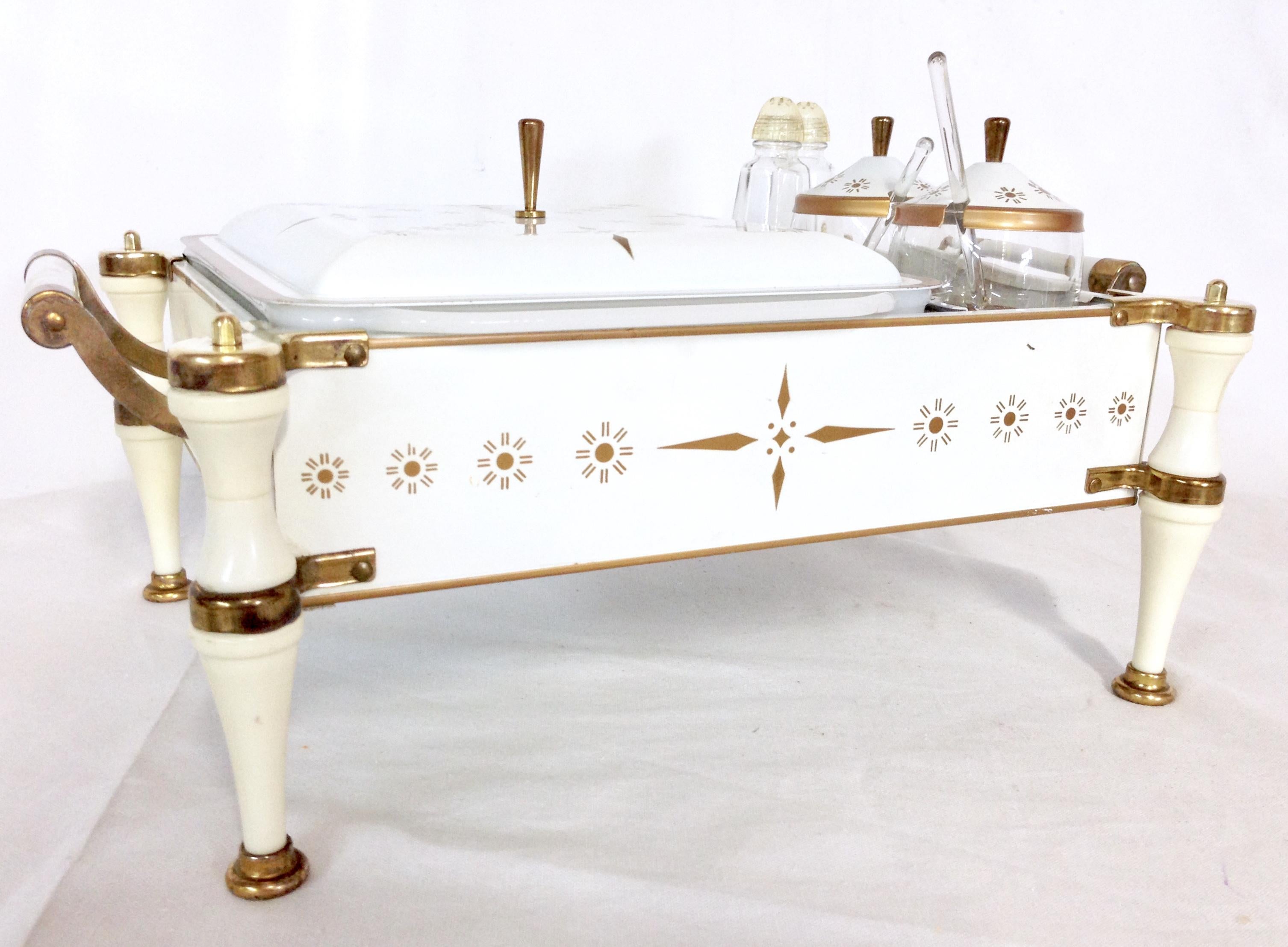 Rare 20th Century enameled metal and brass chafing warming dish set of eleven pieces by, Fire King. For Anchor Hocking. Features a white and gold tone geometric enameled motif, with brass feet, handles and lid knobs.
Set includes, 1 opaque white