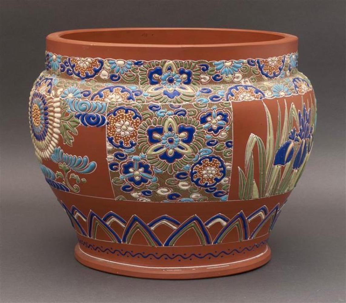 Enameled redware jardinière, 20th century
In ovoid form with enameled decoration of irises and floral rondels. Measures: Diameter 13.25