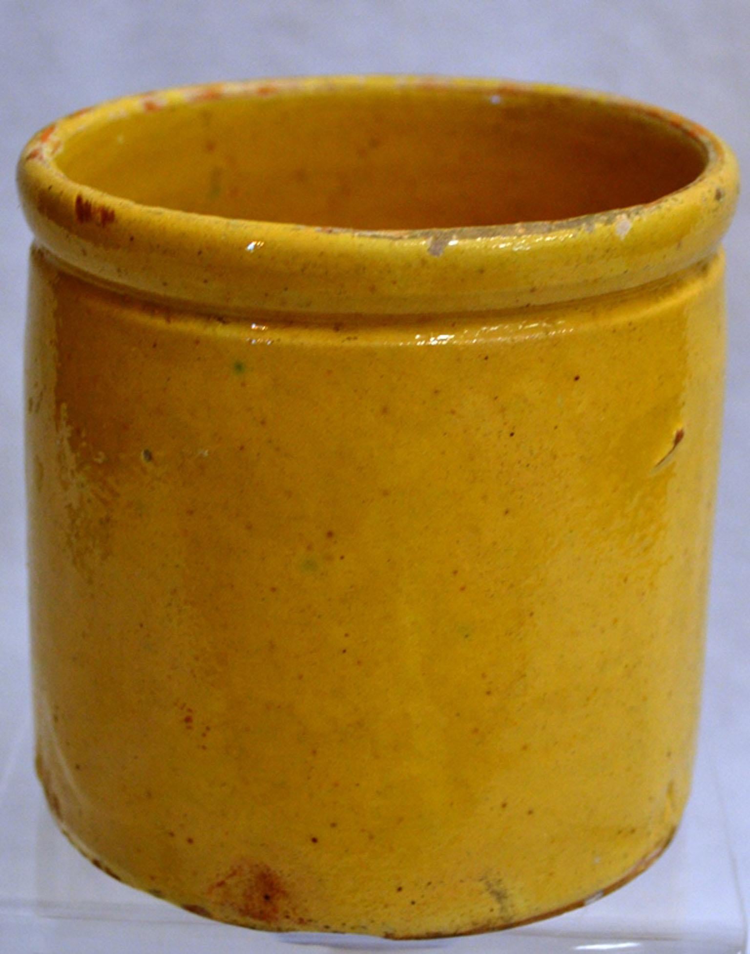 Turn of the century small enameled terracotta pot. Once a common piece of pottery used daily in French kitchens, these earthenware jugs have become showcase pieces sought by designers and collectors. These beautiful vessels offer a depth of color