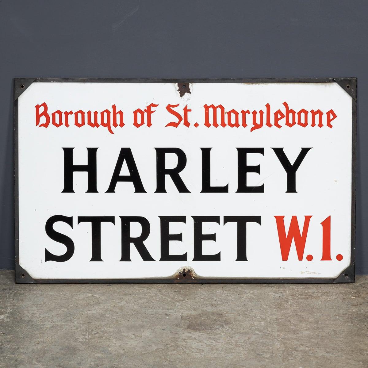 Antique 20th Century enamelled London street sign, crafted for Harley Street, W1 (Central London). This sign features the classic red and black lettering on a white background. A fantastic item and a remarkable piece of history.

CONDITION
In Great