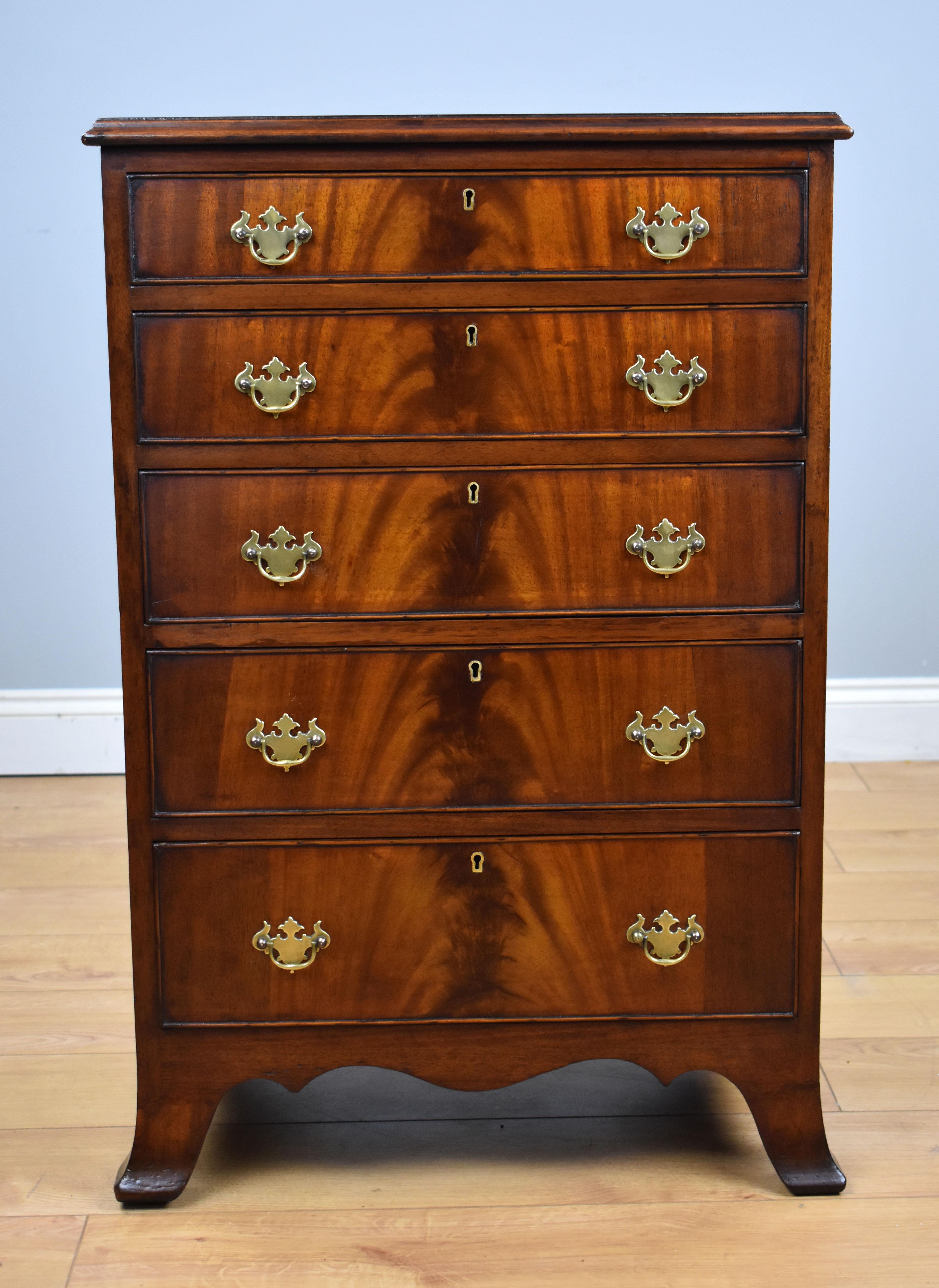 For sale is a good quality antique flame mahogany chest of drawers, having an arrangement of five graduated drawers, each with their original brass handles. The chest is raised on splayed feet and is in very good condition for its age. 

Measures: