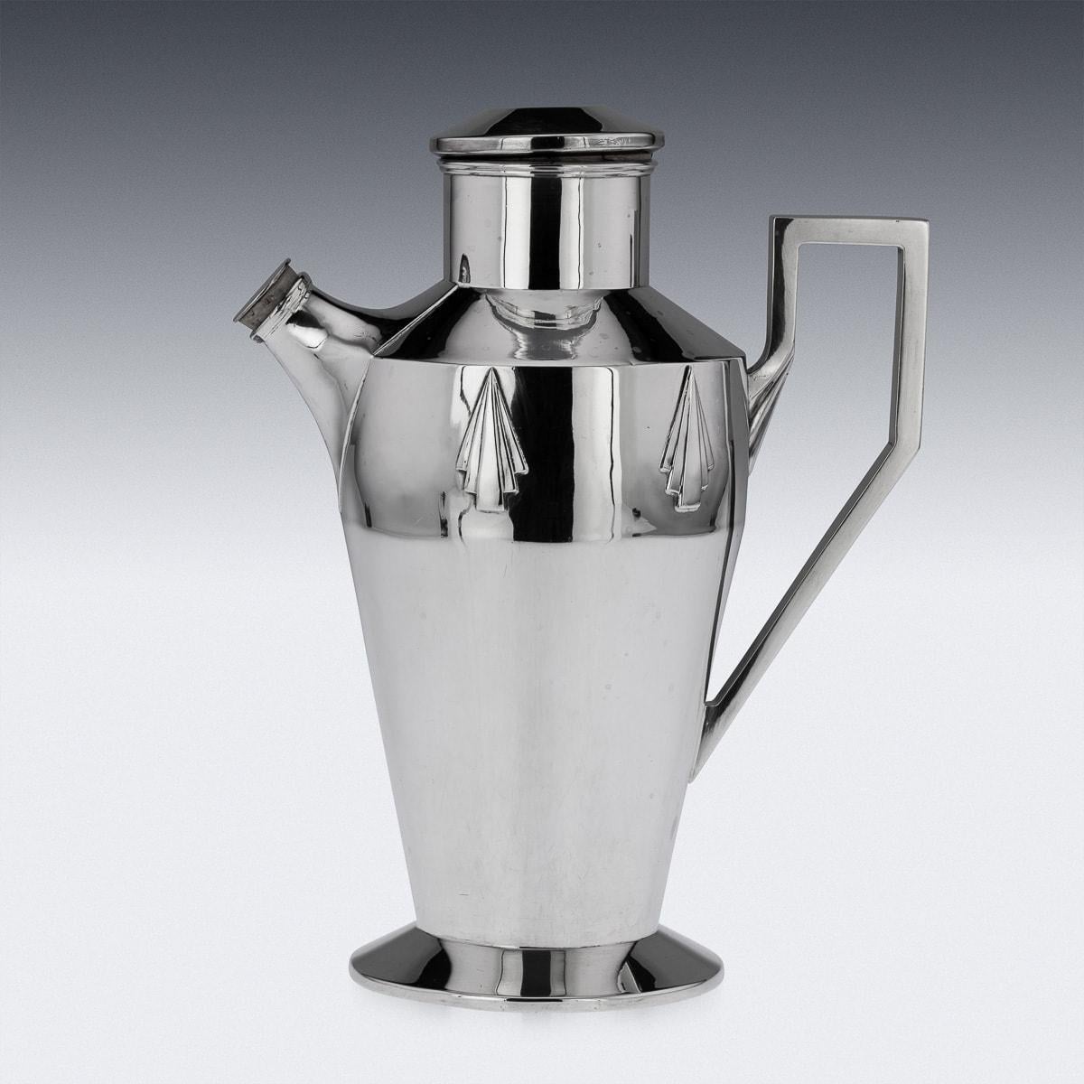 This is quite possibly the most stylish English silver cocktail shaker we have ever encountered - the clean angular handle and applied stylised shell motifs blend wonderfully with the elegant tapering cylindrical body. A real tour-de-force of the