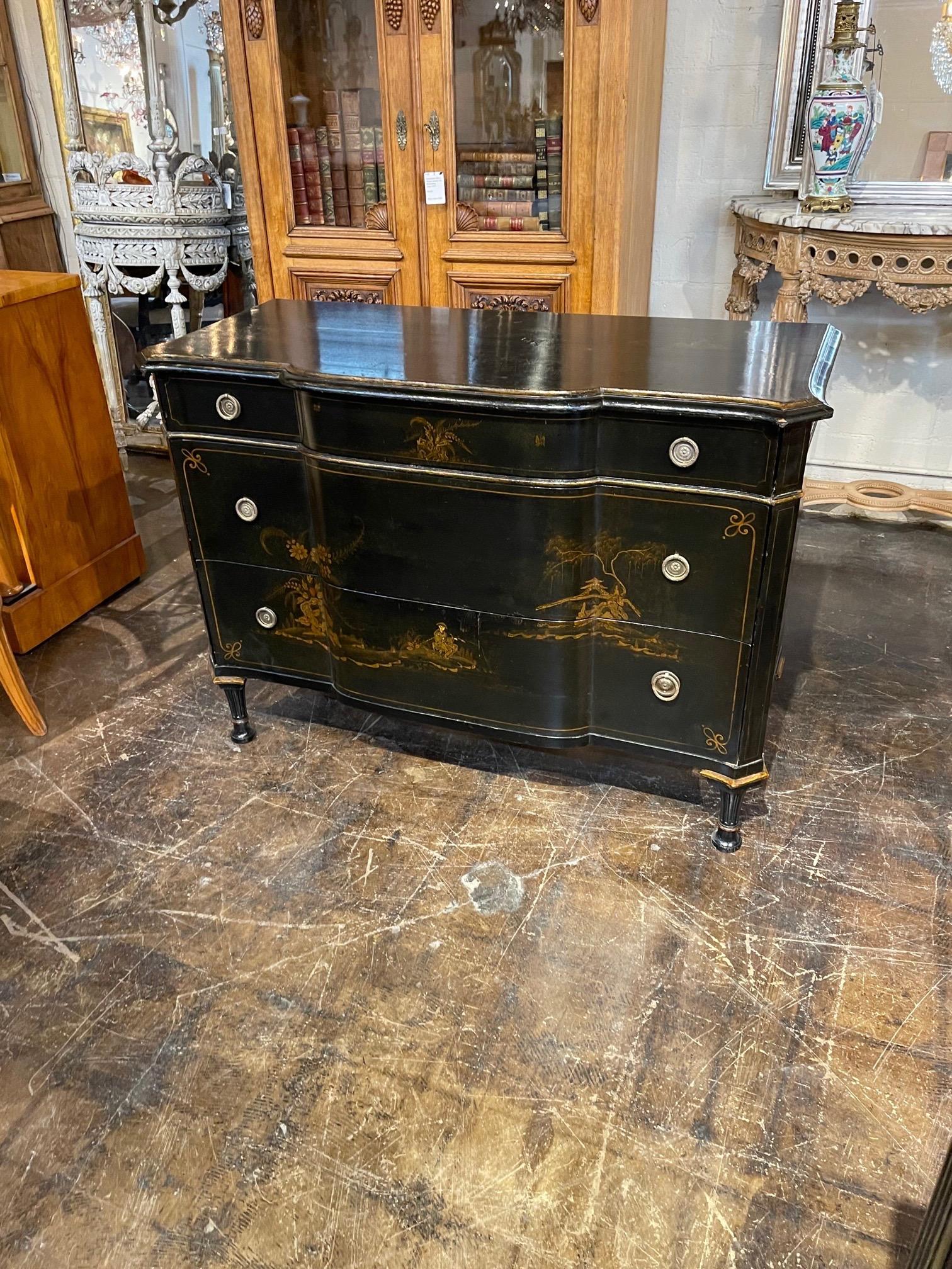 Beautiful Mid 20th century black lacquered Chinoiserie commode. Lovely painted images and pretty hardware as well. A very fine piece!!