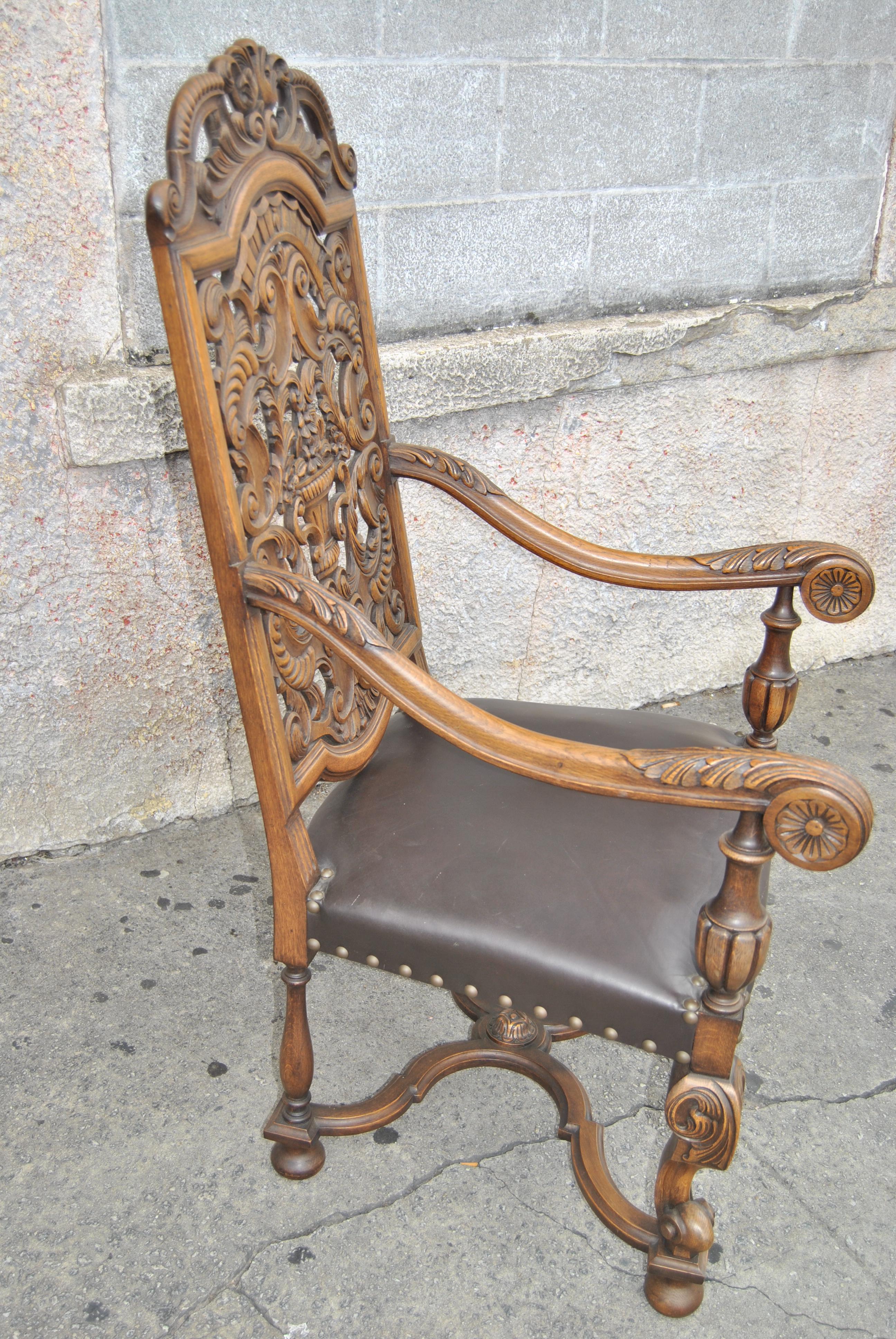 This is a carved solid oak armchair in the Elizabethan atyle. The chair was made in England, circa 1900. All of the carving is hand done and of superior quality and depth. The chair has a fabulously shaped back that is heavily carved. The arms are