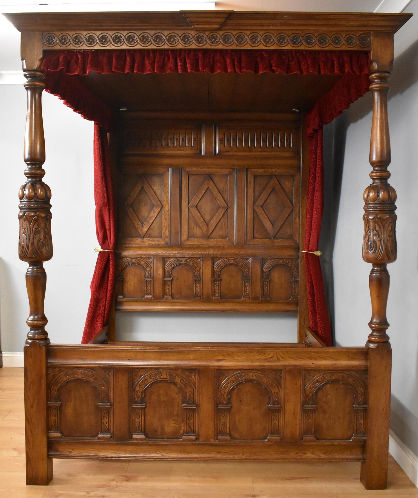 For sale is a good quality Jacobean style oak four poster bed, having a carved top, supported by two turned and carved supports, united by the foot board featuring arched panels. Overall, the bed is in good condition showing minor signs of wear