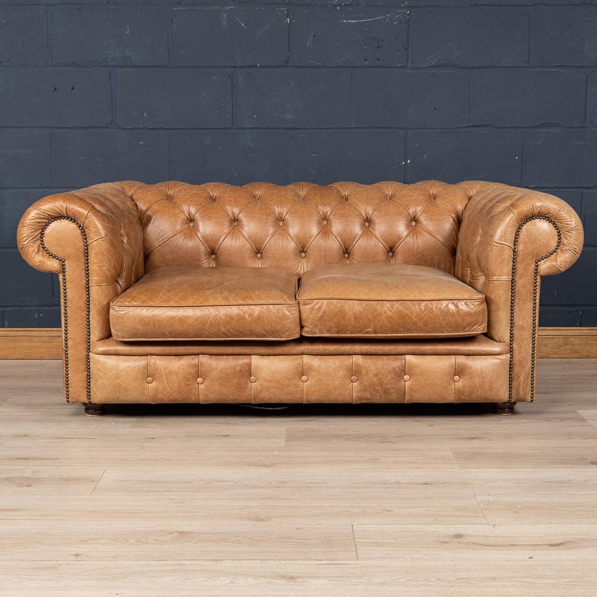 A superb late 20th century leather chesterfield sofa. This is a fashionable item of furniture capable of uplifting the interior space of any contemporary or traditional home, the classic colour combining refined elegance and taste. This particular