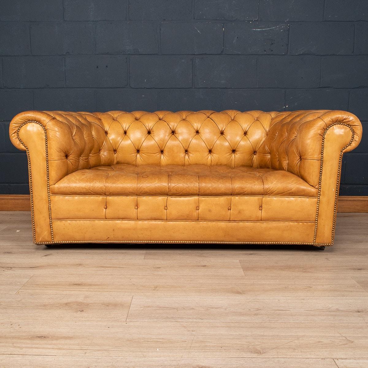 A superb Mid-20th Century leather chesterfield sofa. One of the most elegant models with button down seating, this is a fashionable item of furniture capable of uplifting the interior space of any contemporary or traditional home, the classic colour