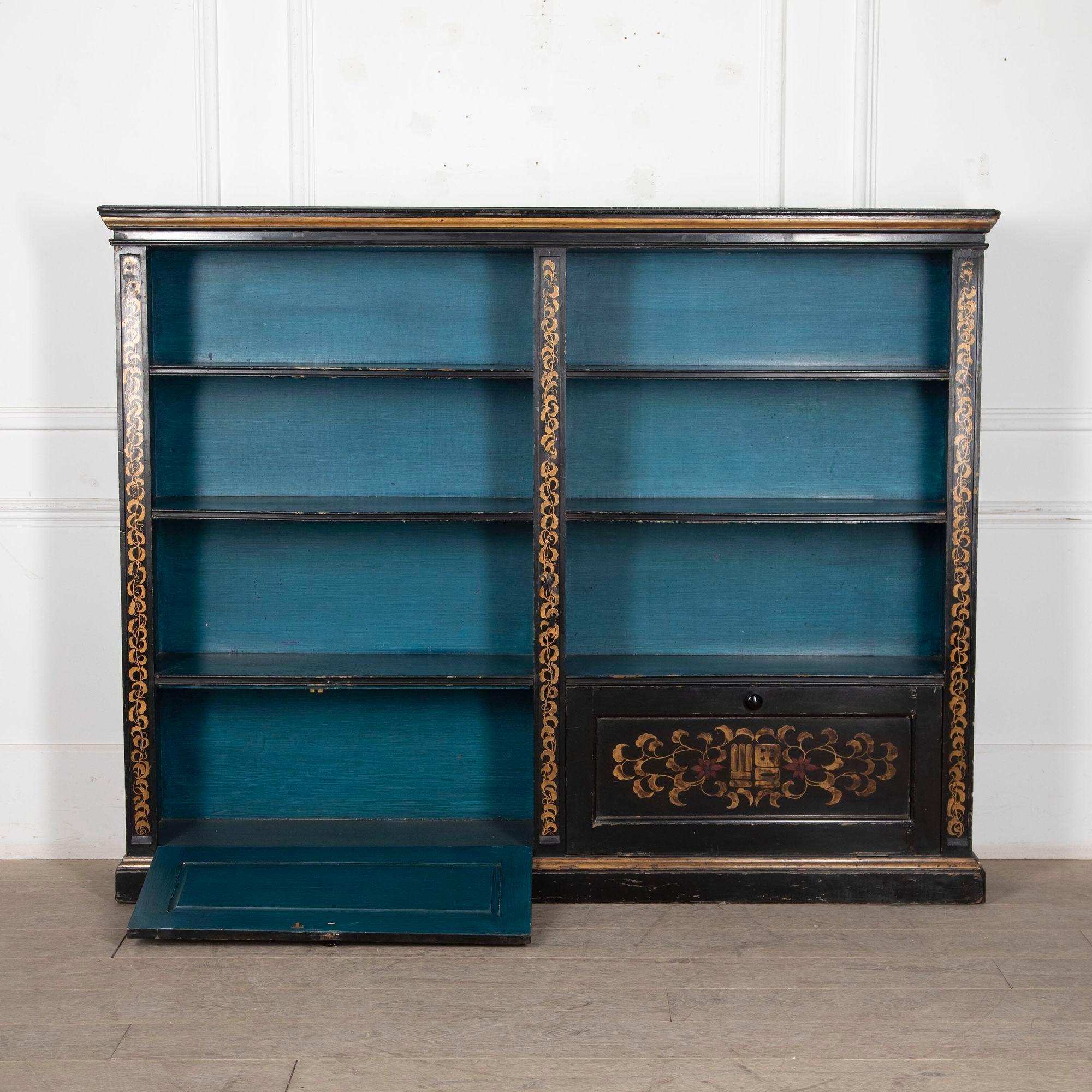 Original 20th century ebonized bookcase with painted chinoiserie decoration and peacock blue interior. 
circa 1920.