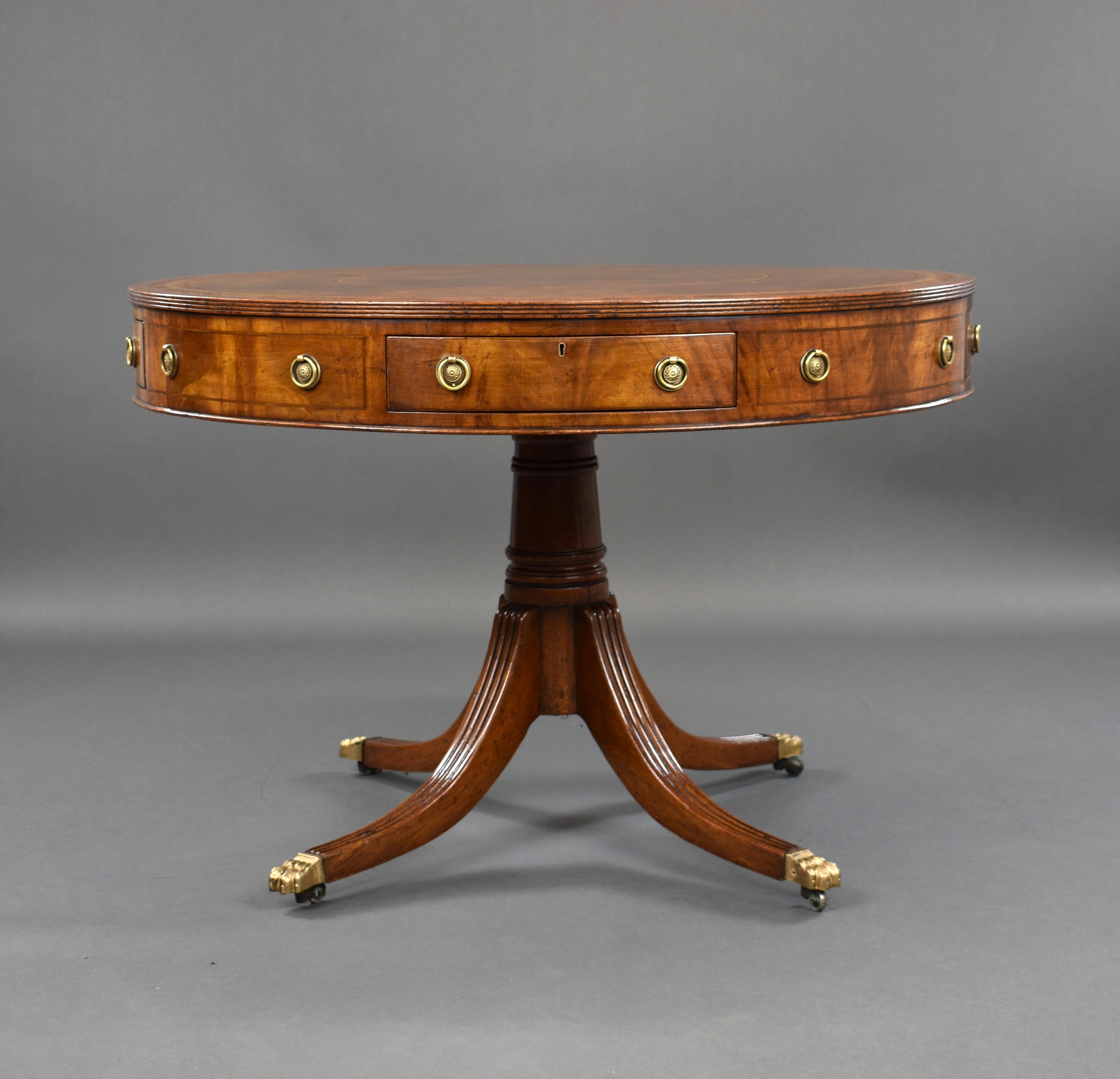 For sale is a good quality Edwardian mahogany drum table, having a leather lined top, above four drawers and four dummy drawers, with a turned stem below standing on four fluted legs raised on brass castors. The table is in very good condition for