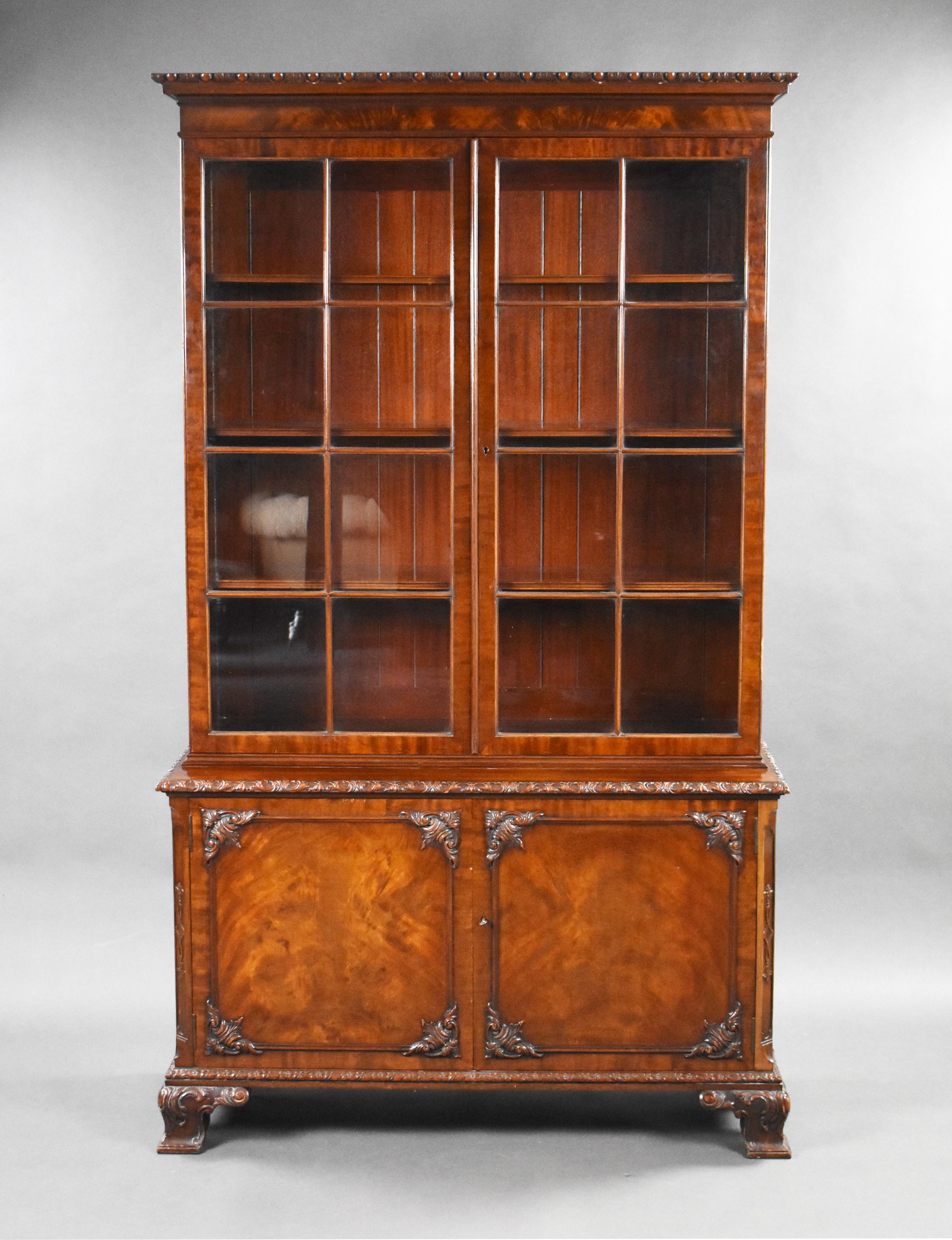 For sale is a good quality Edwardian mahogany bookcase by Waring & Gillows. The two height bookcase having two astregal glazed doors to the top, enclosing adjustable shelves. Having two paneled doors below, standing on carved ogee bracket feet. The