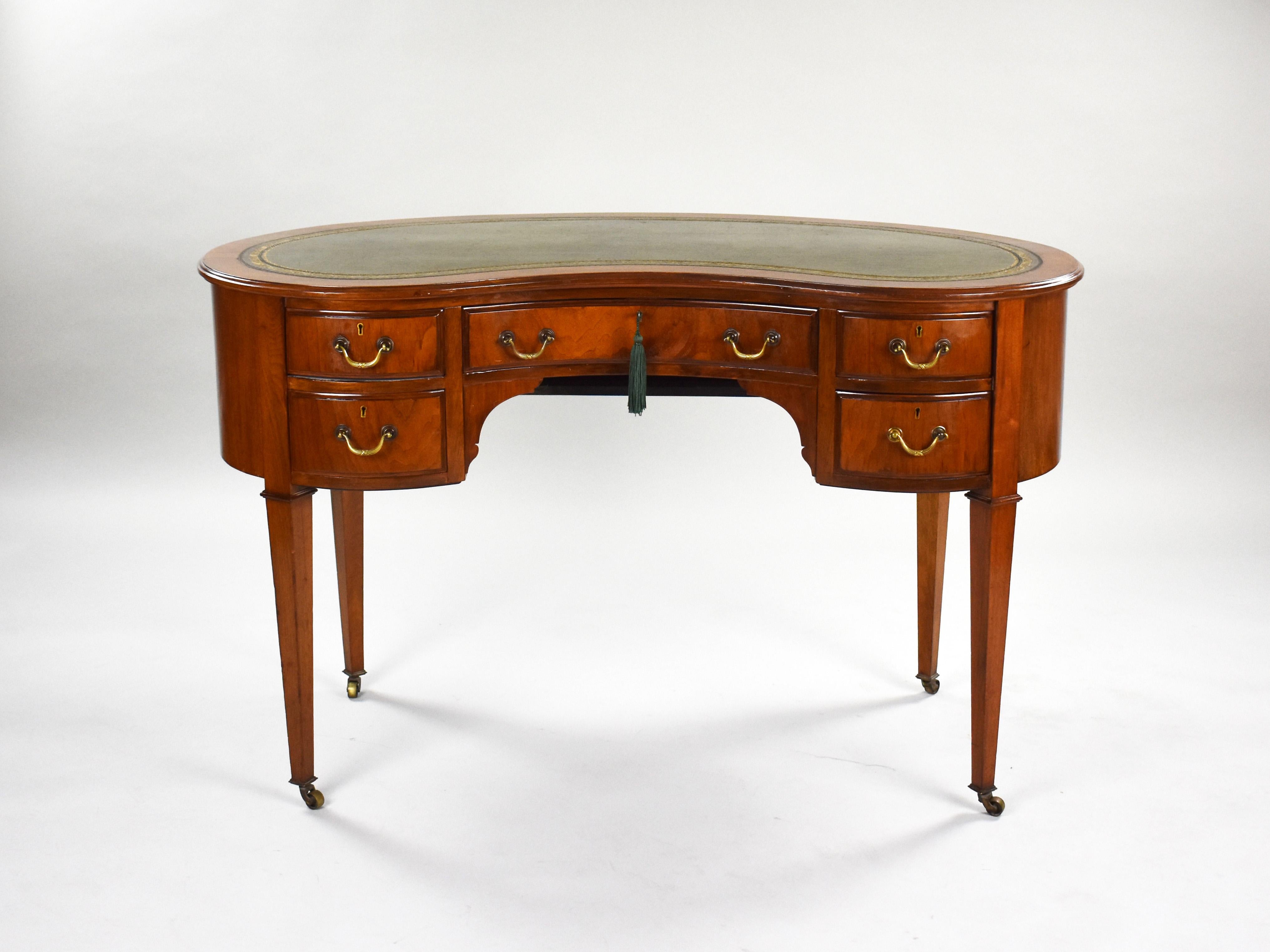 For sale is a good quality Edwardian mahogany kidney shaped desk. The top having a green leather insert above five drawers. The desk stands on tapered legs terminating on castors. This piece is in very good condition, showing minor signs of wear