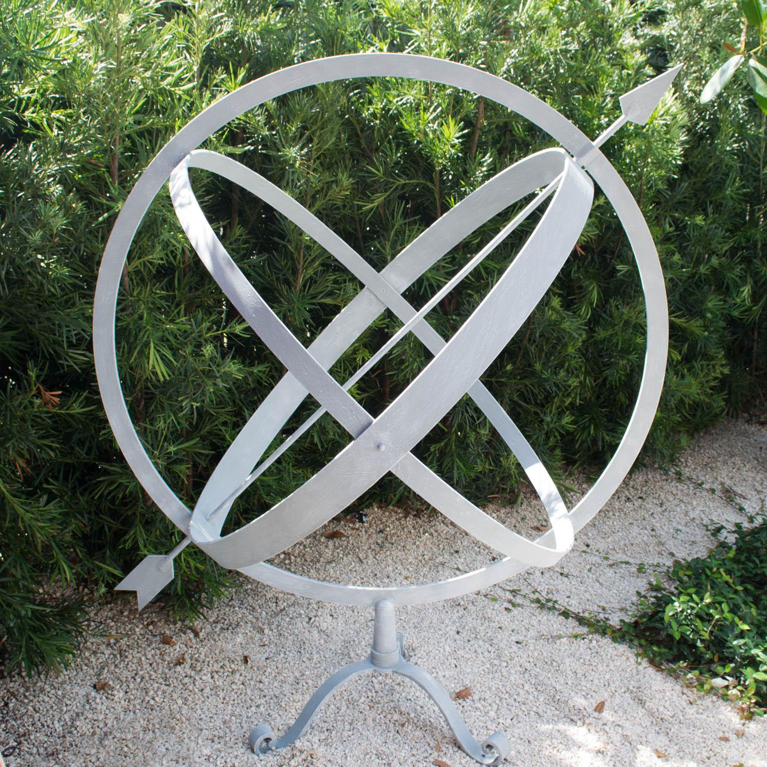 A vintage, simple yet stunning very large armillary sphere pierced with an arrow, mounted upon a three foot scrolled base, which can be additionally screwed into hardscape area as holes are provided for additional stability, in good condition. Wear
