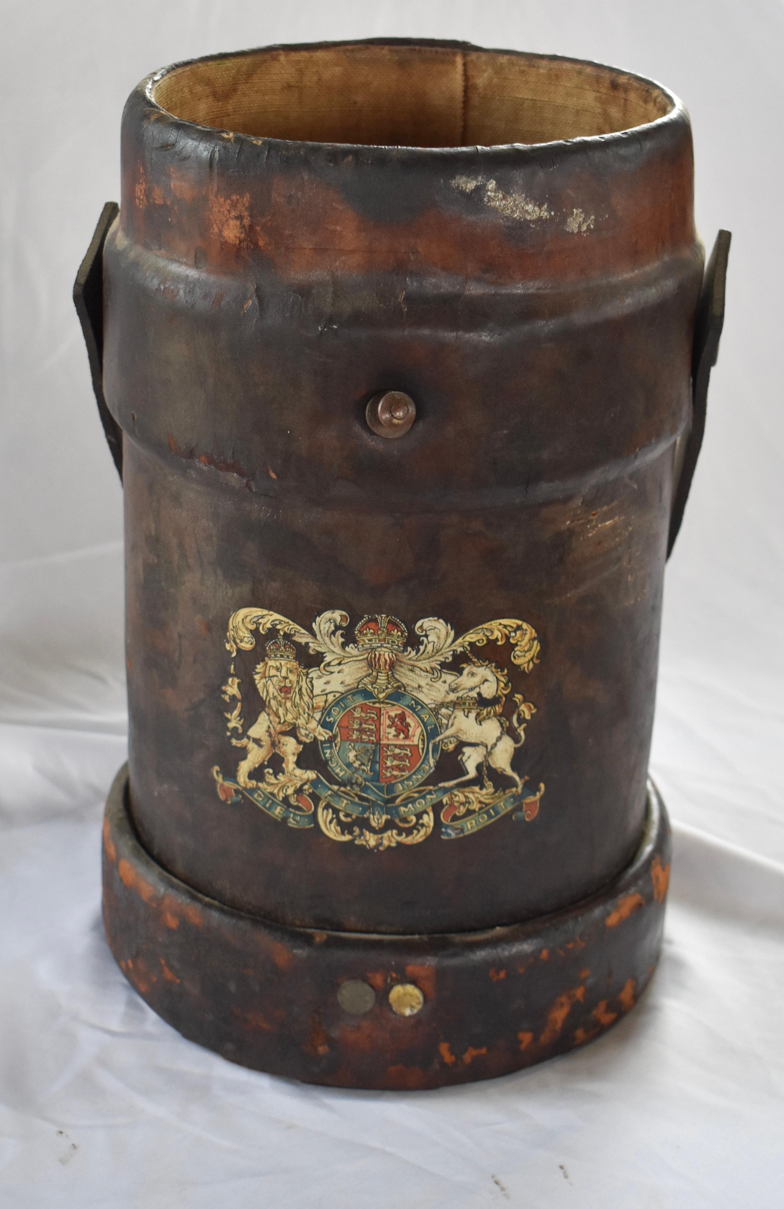 Cordite buckets were used by the British navy to carry cordite, a propellant that was used to replace gunpowder. Because of their purpose, cordite buckets were built using specific materials: cork, cloth and leather. 
The leather was used on the