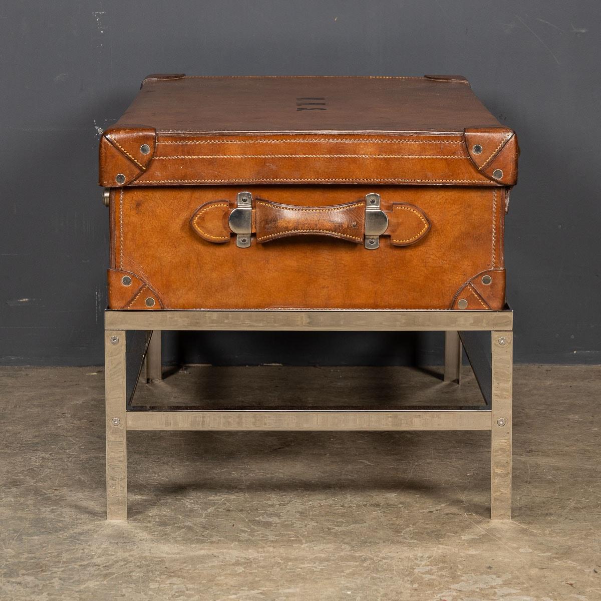 Antique early 20th Century trunk, lined with the original fabric in a champagne colour. This trunk comes with original polished metal locks and leather handles. Applied on the trunk lid is the initials W.H.S. Inside the trunk lid is a small pouch