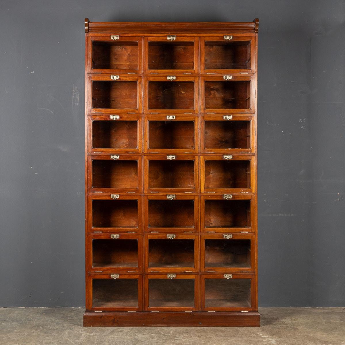 A 1930s mahogany haberdashery with twenty one drop front glass doors each with original brass catches a stunning high quality piece. A very practical and a truly wonderful conversation piece capable of transporting the imagination to a bygone