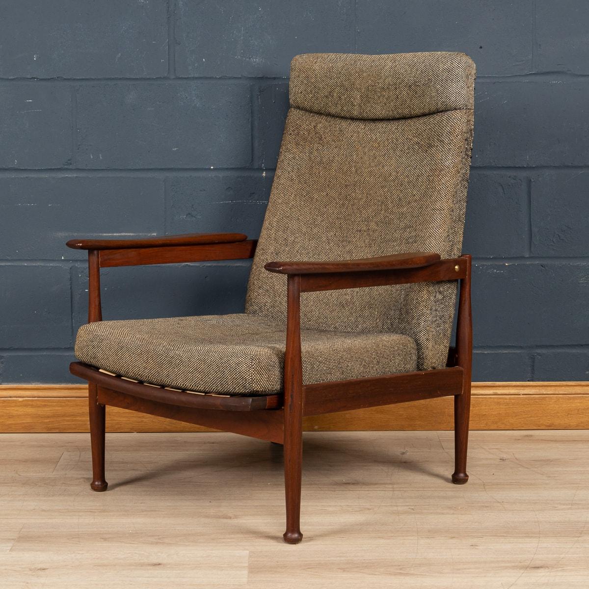 A mid century 'Manhattan' reclining armchair by Guy Rogers c1960's. A solid teak afromosia frame with a high backrest shaped arms and stands on turned tapering legs with 3 seating positions that is set from under the seat cushion. The chair is in