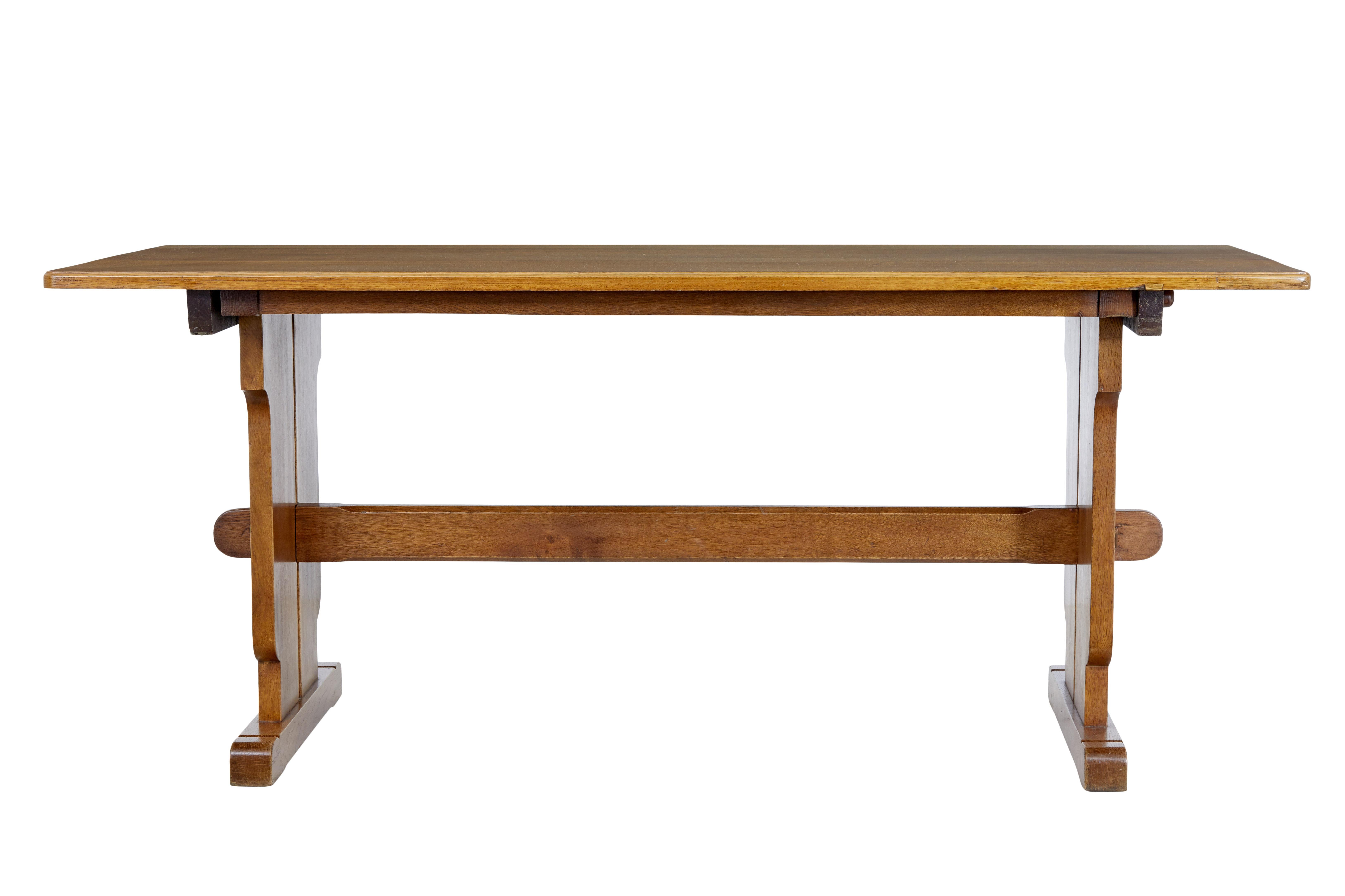 20th century english oak trestle dining table circa 1930.

Good quality table which shows deco and moving towards modernism design.

Solid oak rectangular top which is held to the trestle end supports by pegs, central stretcher running between